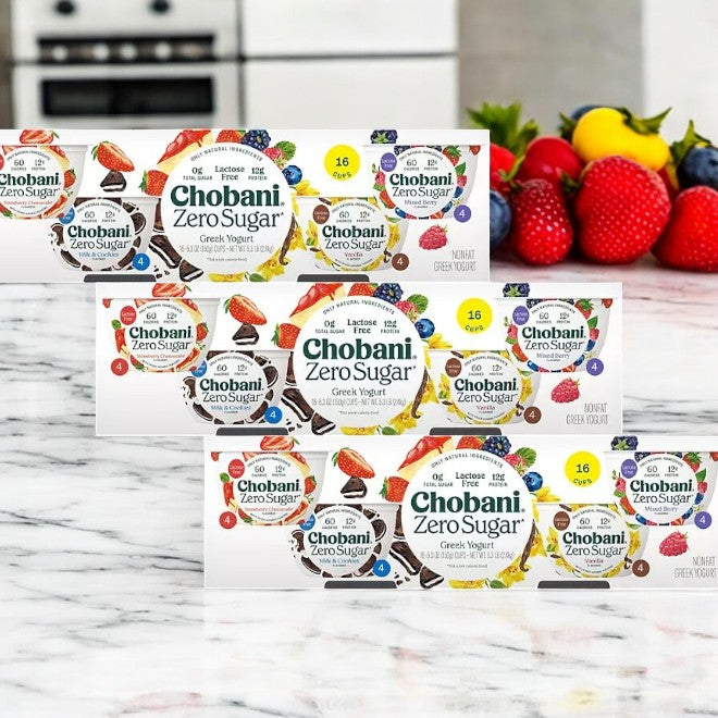 3 cases of Chobani Zero Sugar Nonfat Blended Greek Yogurt Variety Pack are neatly arranged in rows, featuring a colorful assortment of fruits like strawberries and blueberries in the background.