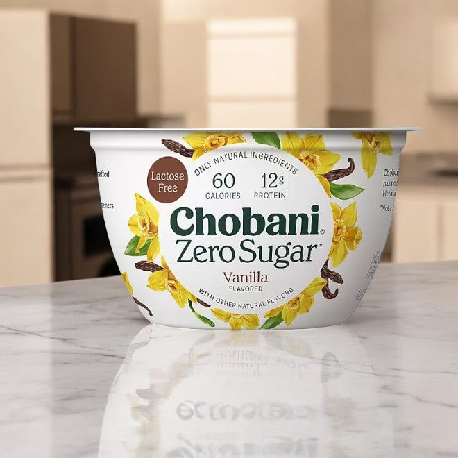 The Chobani Zero Sugar Nonfat Blended Greek Yogurt Variety Pack highlights features such as being lactose-free, with 60 calories and 12g of protein, elegantly displayed on a marble countertop.