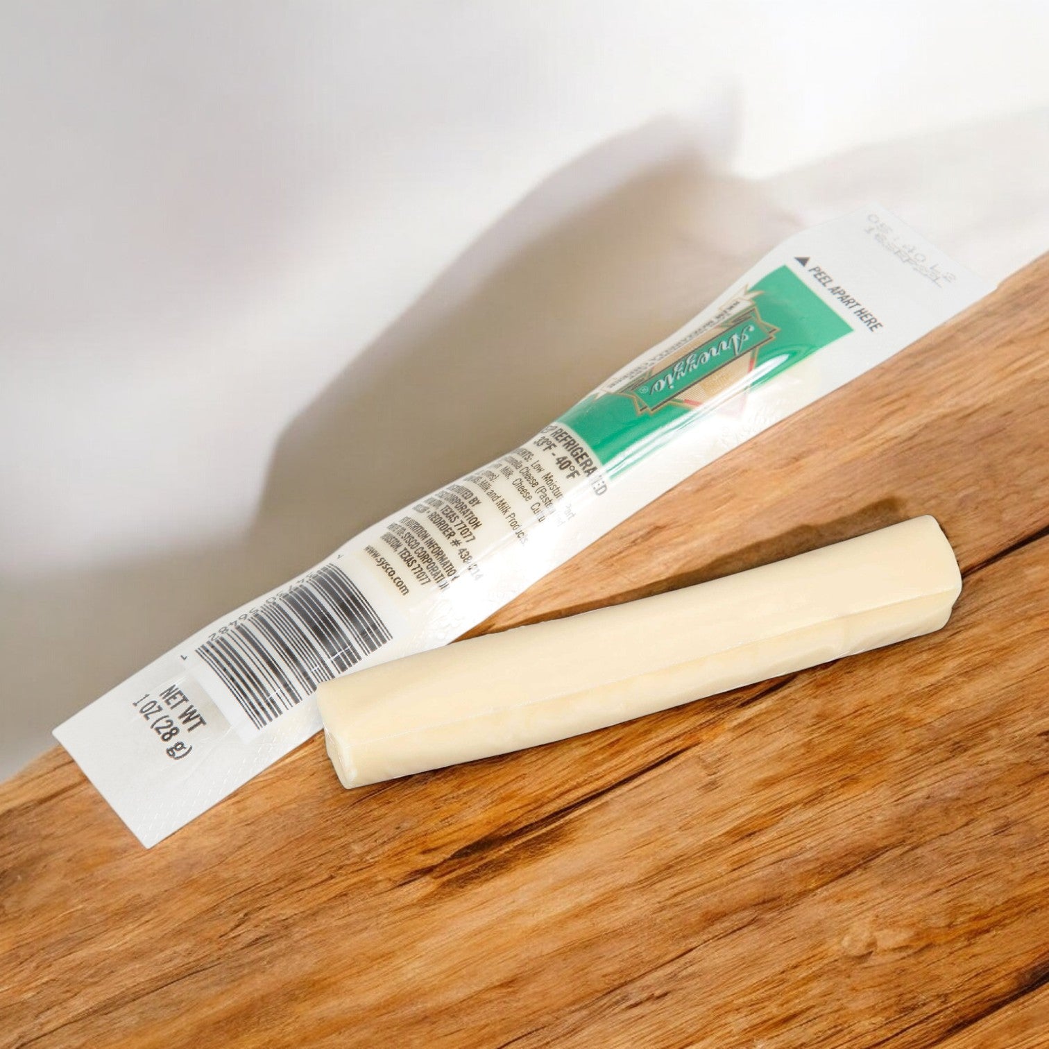 An Arrezzio Imperial Cheese Mozzarella String, from a 168-count case, is placed on a wooden surface next to its opened packaging displaying a barcode and product information. These bulk mozzarella cheese sticks offer a high-protein snack option that’s perfectly suited for those seeking convenience without sacrificing nutrition.