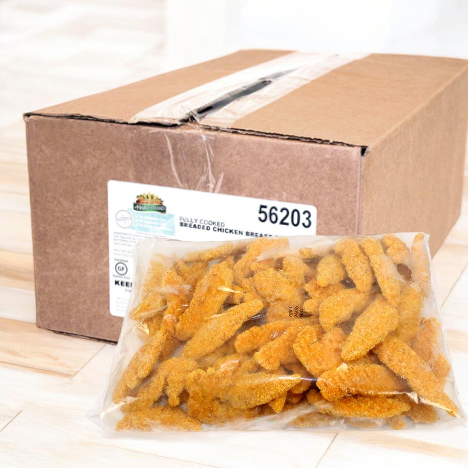 A sealed box labeled "Harvestland Gluten Free Fully Cooked Breaded Chicken Breast Tenders" from Easy Lunches is next to an open plastic bag containing breaded chicken breast tenders.