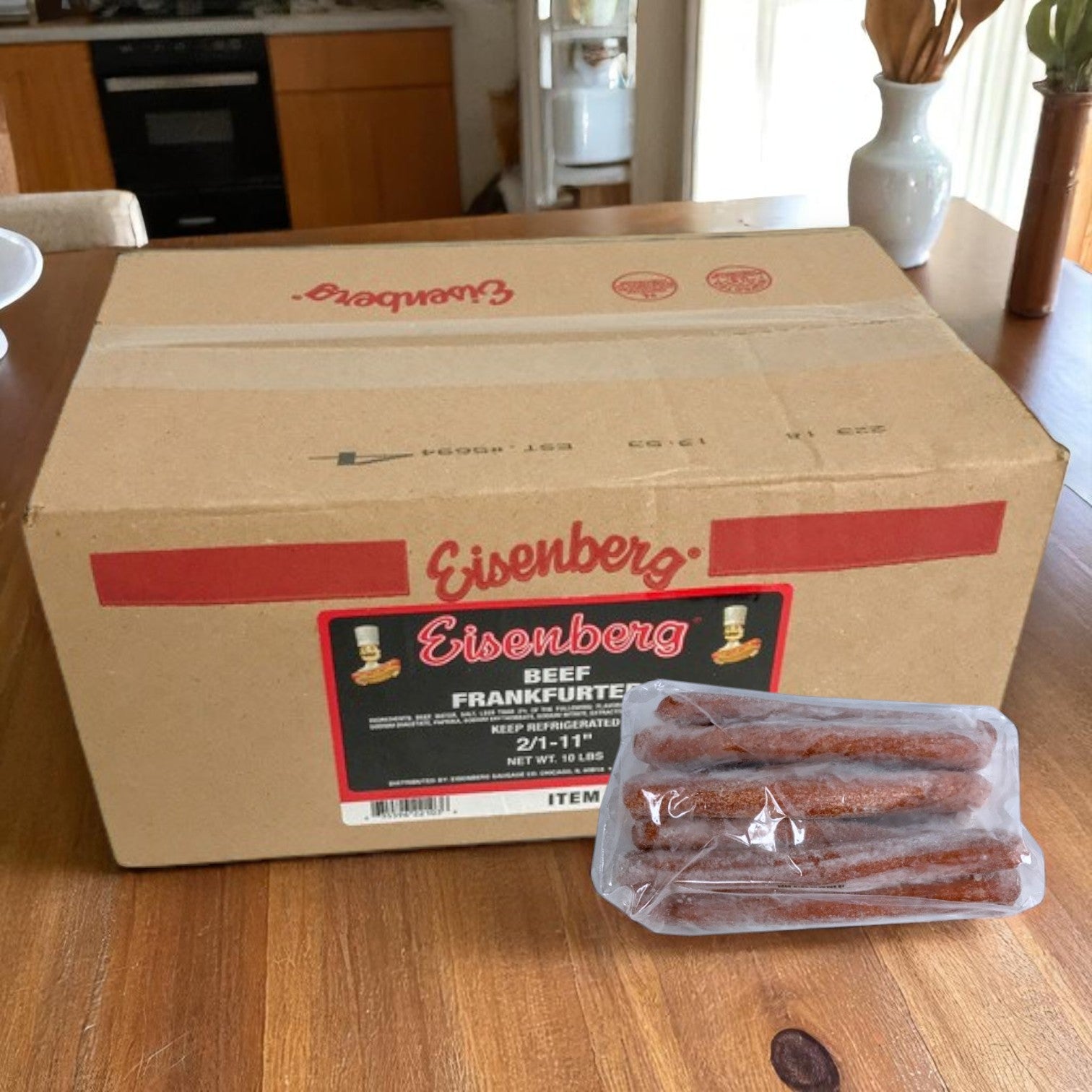 A large Easy Lunches box labeled "Eisenberg All Beef Gourmet Frankfurters – 11 Inch, 10 lb Case (20 count)" sits on a table, with a sealed pack of frankfurters in front—ideal for making authentic Chicago-Style Hot Dogs.