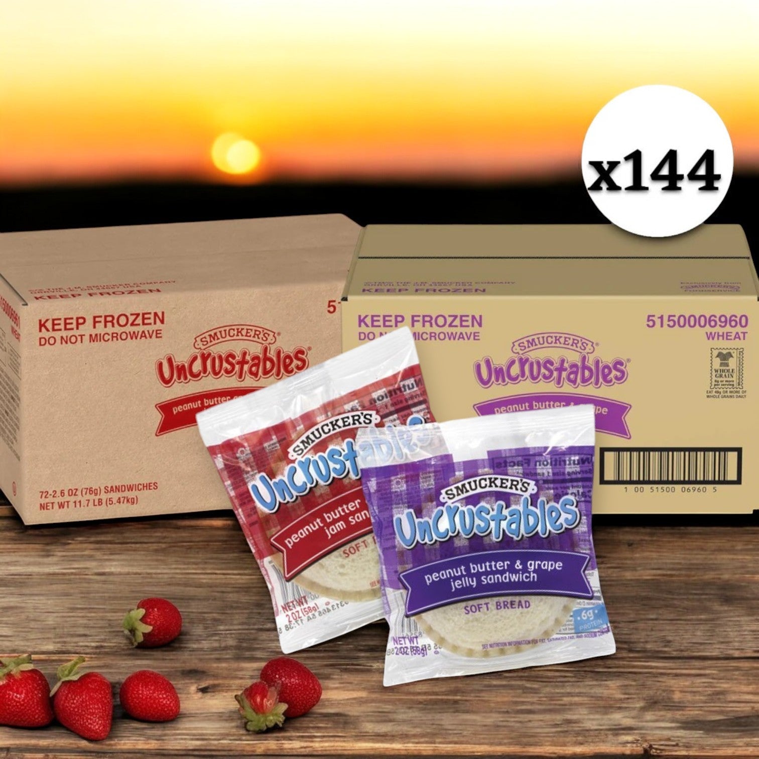 A package labeled "Uncrustables 144 count" by Uncrustable Smuckers, featuring 72 Grape Jam and 72 Strawberry Jam sandwiches, stands prominently. In the foreground, a bundle displays two packs of sandwiches with one showcasing strawberry jam, surrounded by scattered strawberries on a wooden surface against a sunset backdrop.