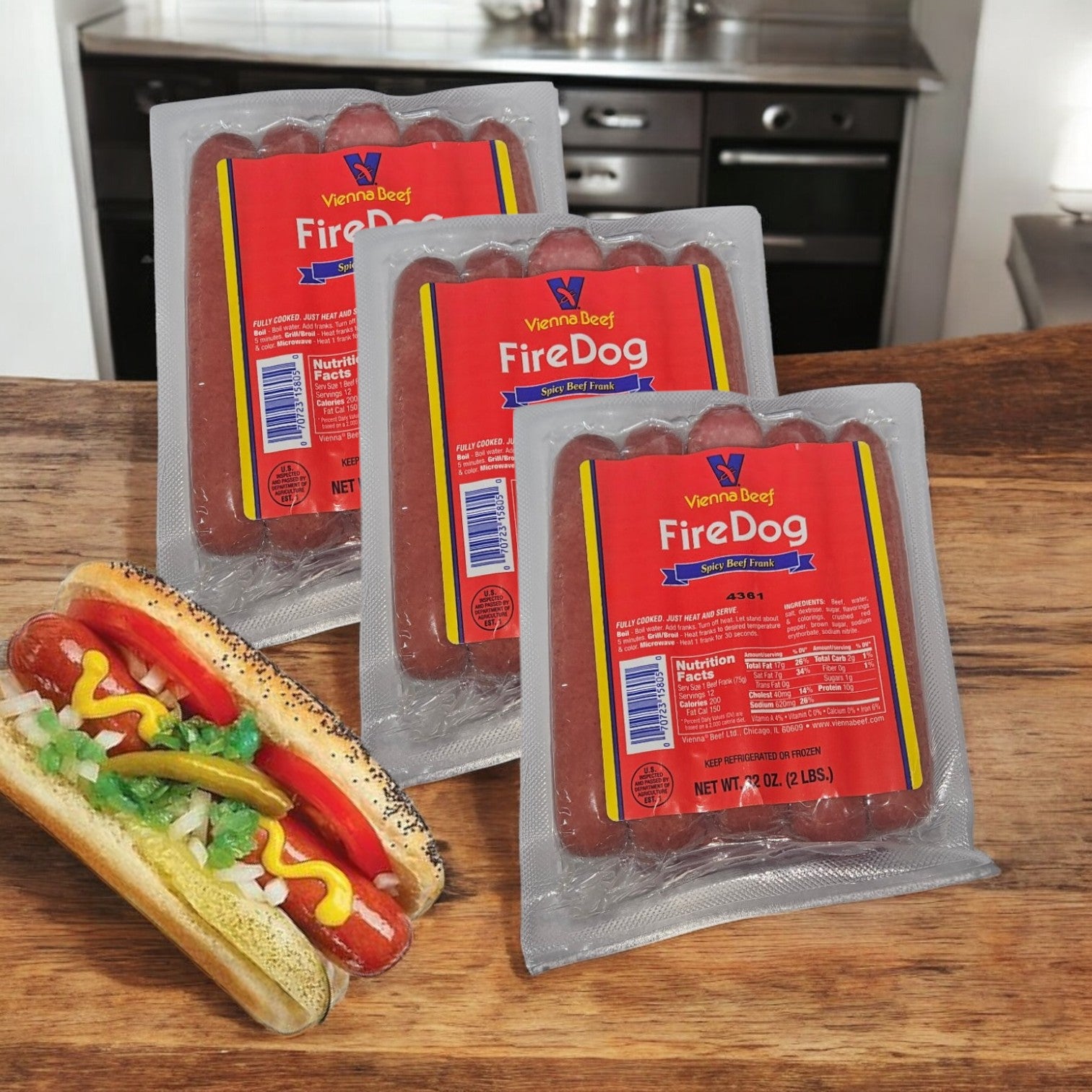 Three packs of Vienna Beef Fire Spicy Jumbo Franks (36 total franks) are displayed next to a premium beef hot dog with toppings on a kitchen counter, highlighting the irresistible appeal of these spicy sausages.