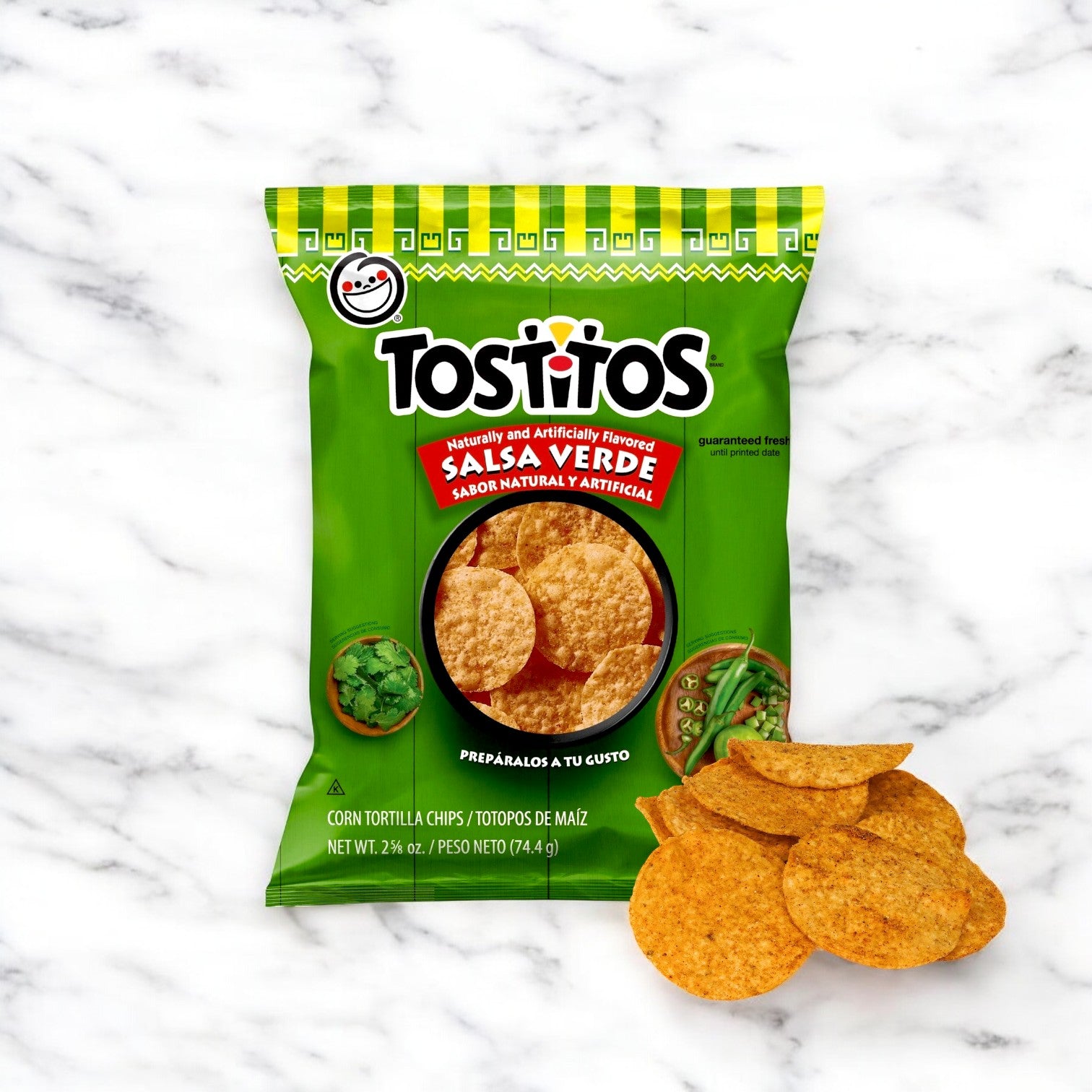 A bag of Tostitos Salsa Verde Tortilla Rounds – 28 Pack (2.63 oz Each) tempts snack lovers from a white marble surface, with a few chips ready for dipping and snacking.