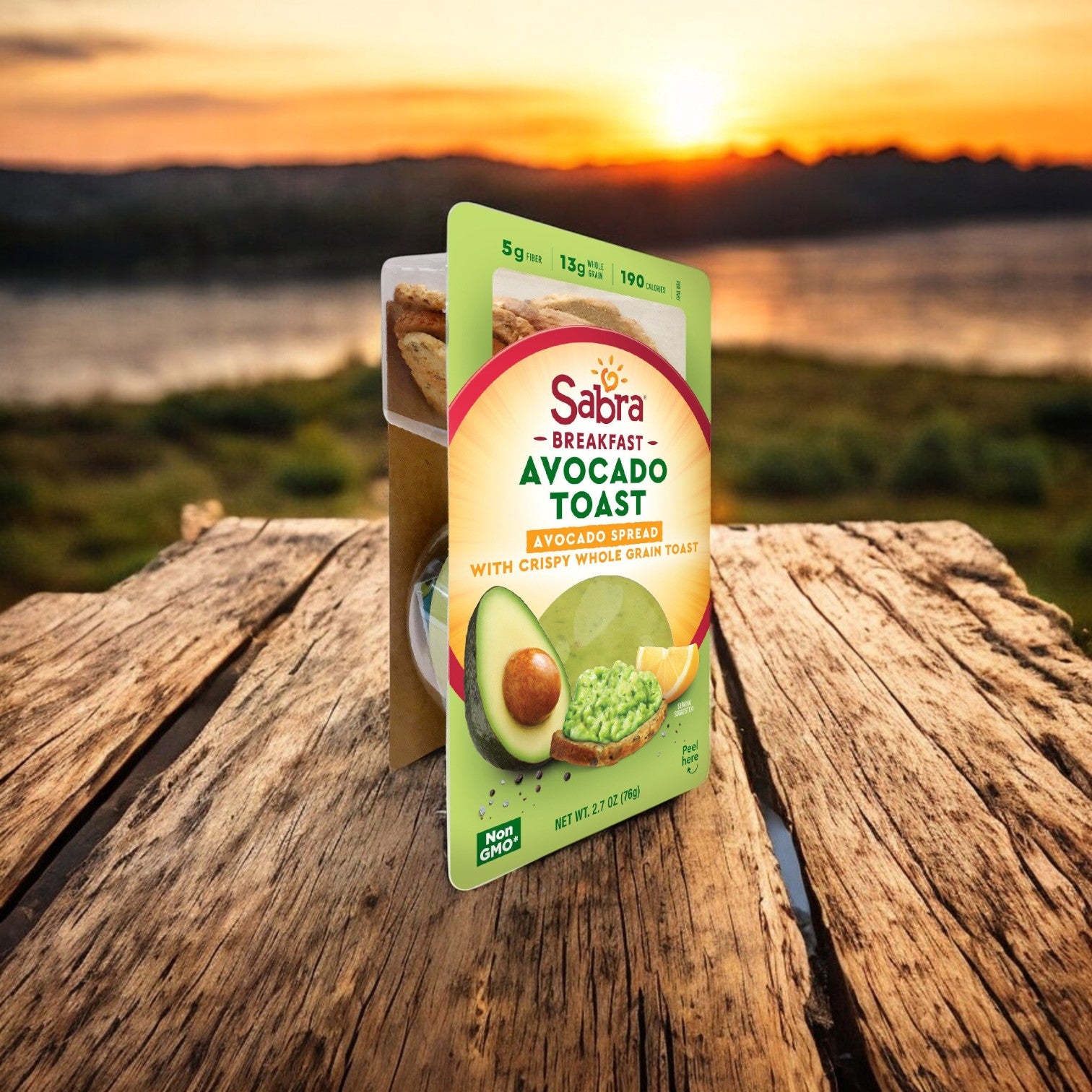 A package of Sabra Avocado Chunky Spread with Toast, 8 Count, 2.7 oz each, and Sabra Classic Hummus is shown in a scenic outdoor setting, perfectly capturing authentic flavor.