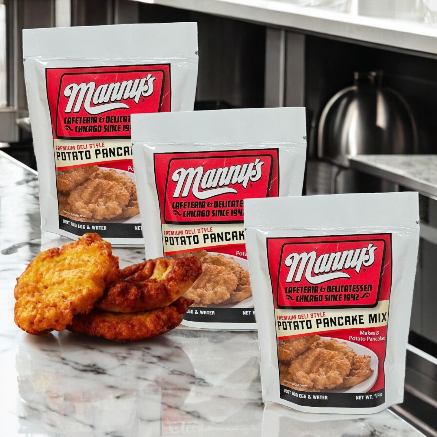 Three packets of Manny's Potato Pancake Mix-3 Count sit on the counter with three delicious homemade pancakes, a savory delight for your taste buds.