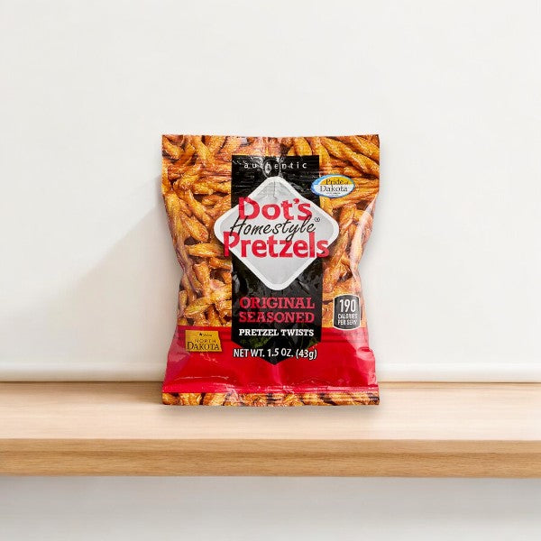 A bag of Dot's Homestyle Original Pretzels Snack Bags - 1.5oz - 1 Count is placed on a wooden surface against a plain background, promising a unique snacking experience. The red and yellow bag showcases a clear image of the delectable pretzels inside.