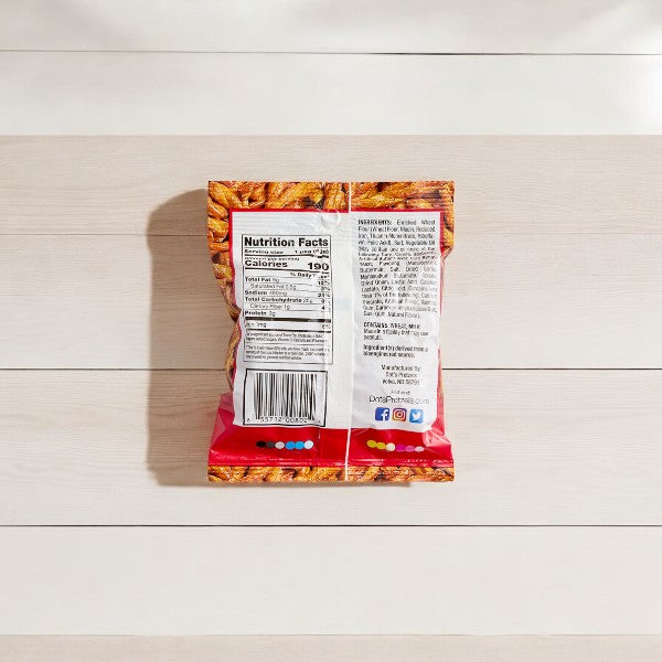 Back view of a Dot's Homestyle Original Pretzels Snack Bag (1.5 oz, 1 count) on a light wooden surface, showcasing the nutrition facts, ingredients, barcode, and social media icons. Discover the unique snacking experience with Dot's Original Seasoned Pretzel Twists.