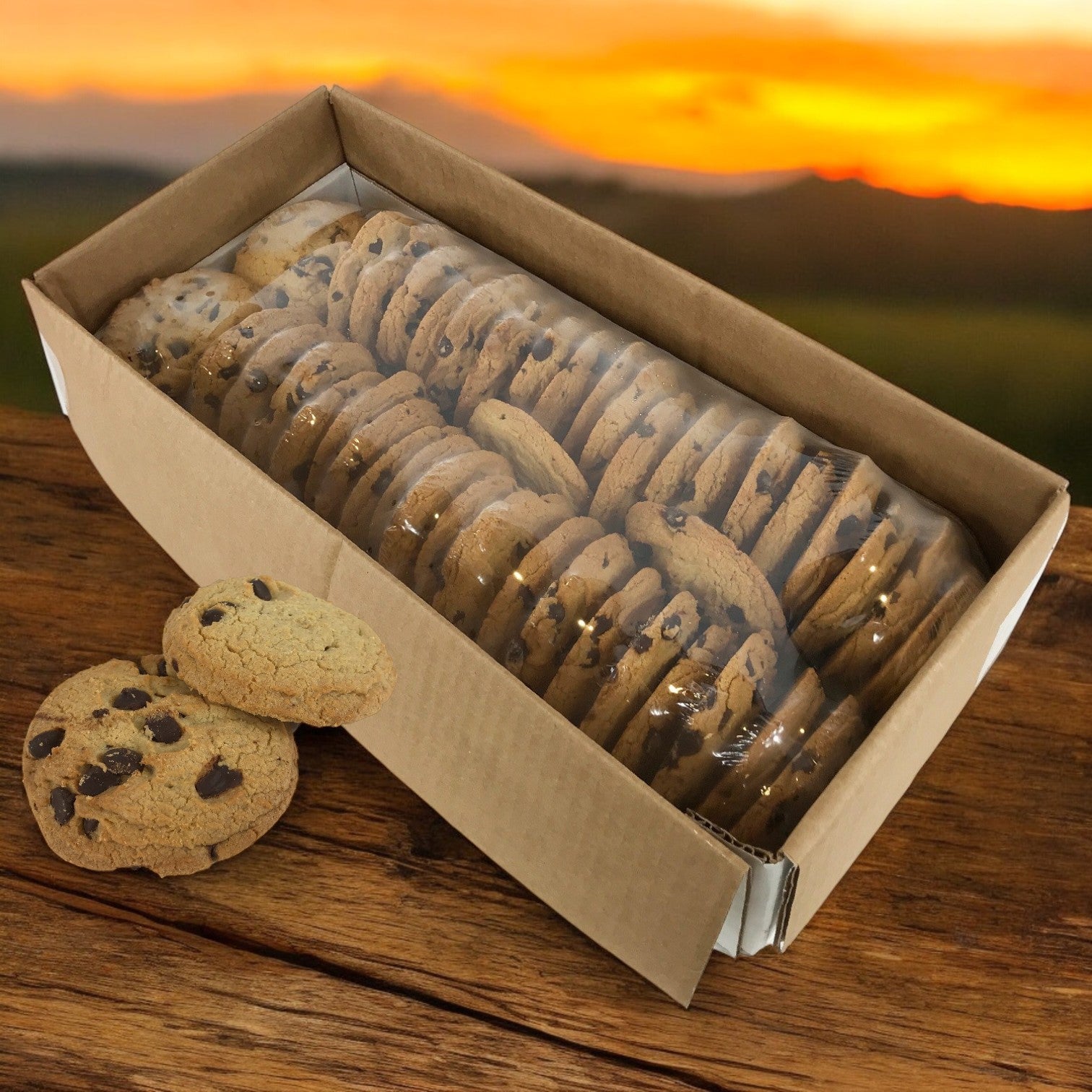 David's Cookies - Chocolate Chip Cookies (Baked, Thaw & Serve, 48/2 oz) are displayed on a wooden surface, their chewy texture shimmering in the warm sunset glow.