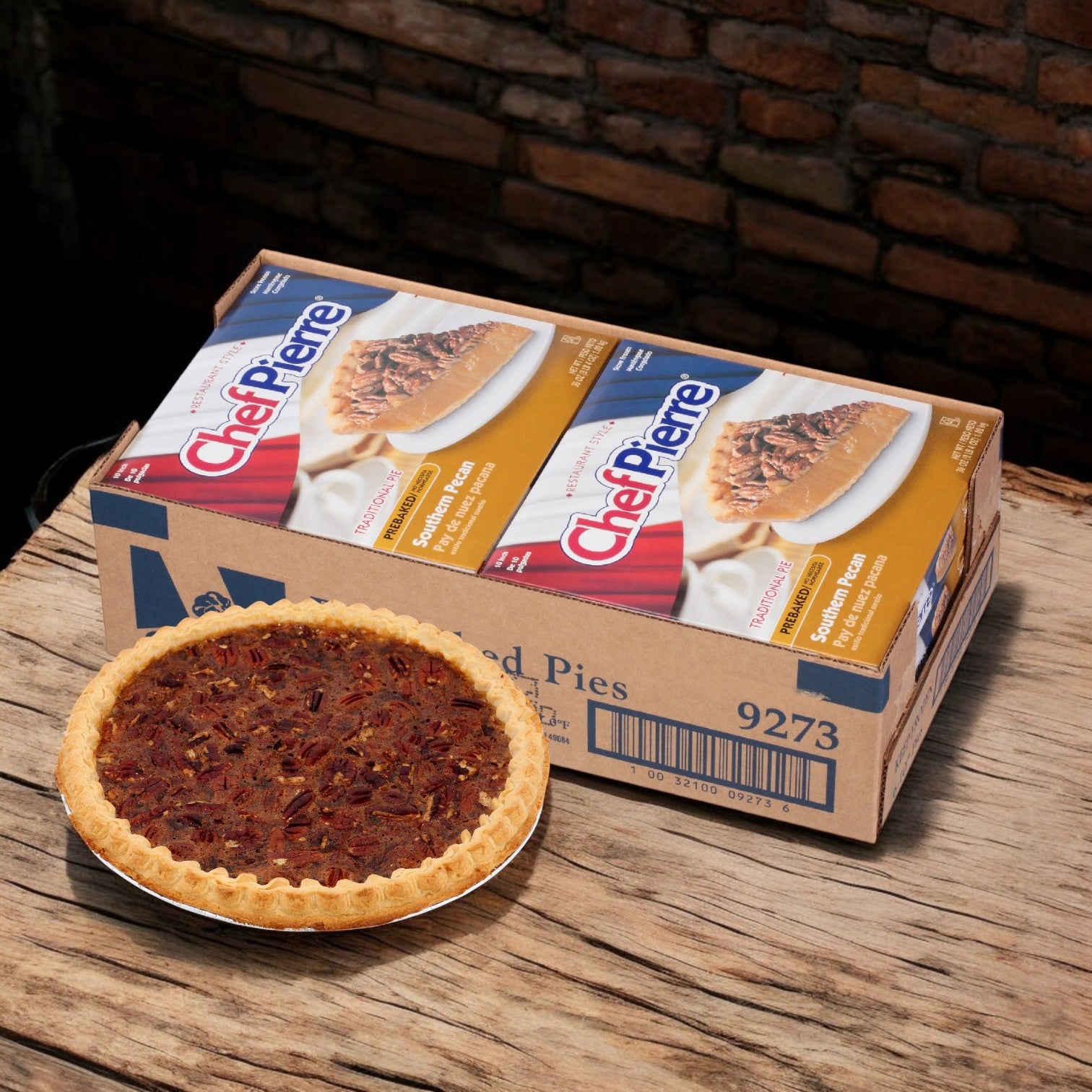 A boxed set of Chef Pierre Southern Pecan Pie (10", 6/36 oz) rests on a wooden surface next to a delightful pecan pie, accompanied by a luscious Banana Crème Pie with creamy banana filling, perfect for those who crave a unique frozen dessert.