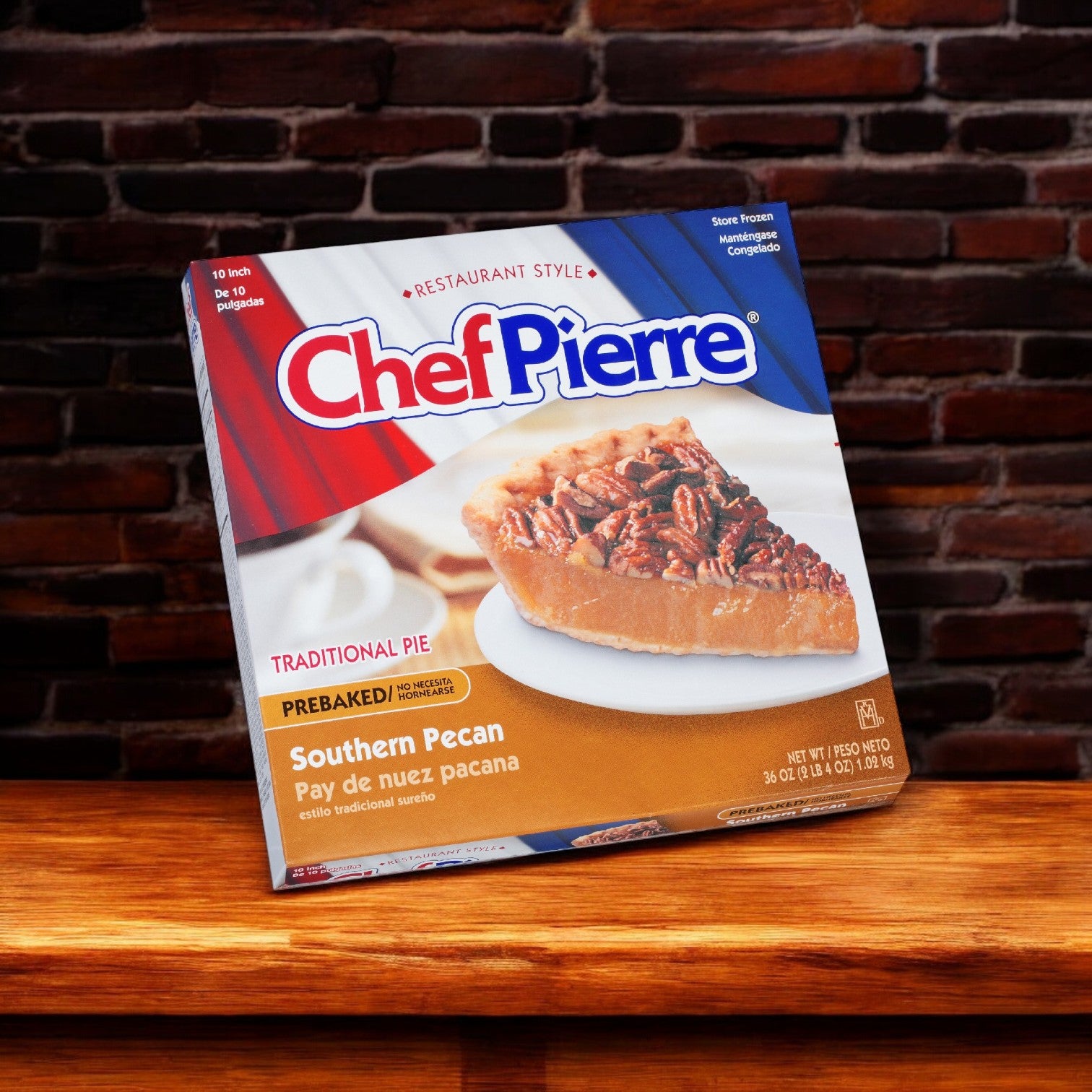 A box of Chef Pierre Southern Pecan Pie (10", 6/36 oz) is displayed against a brick wall backdrop.