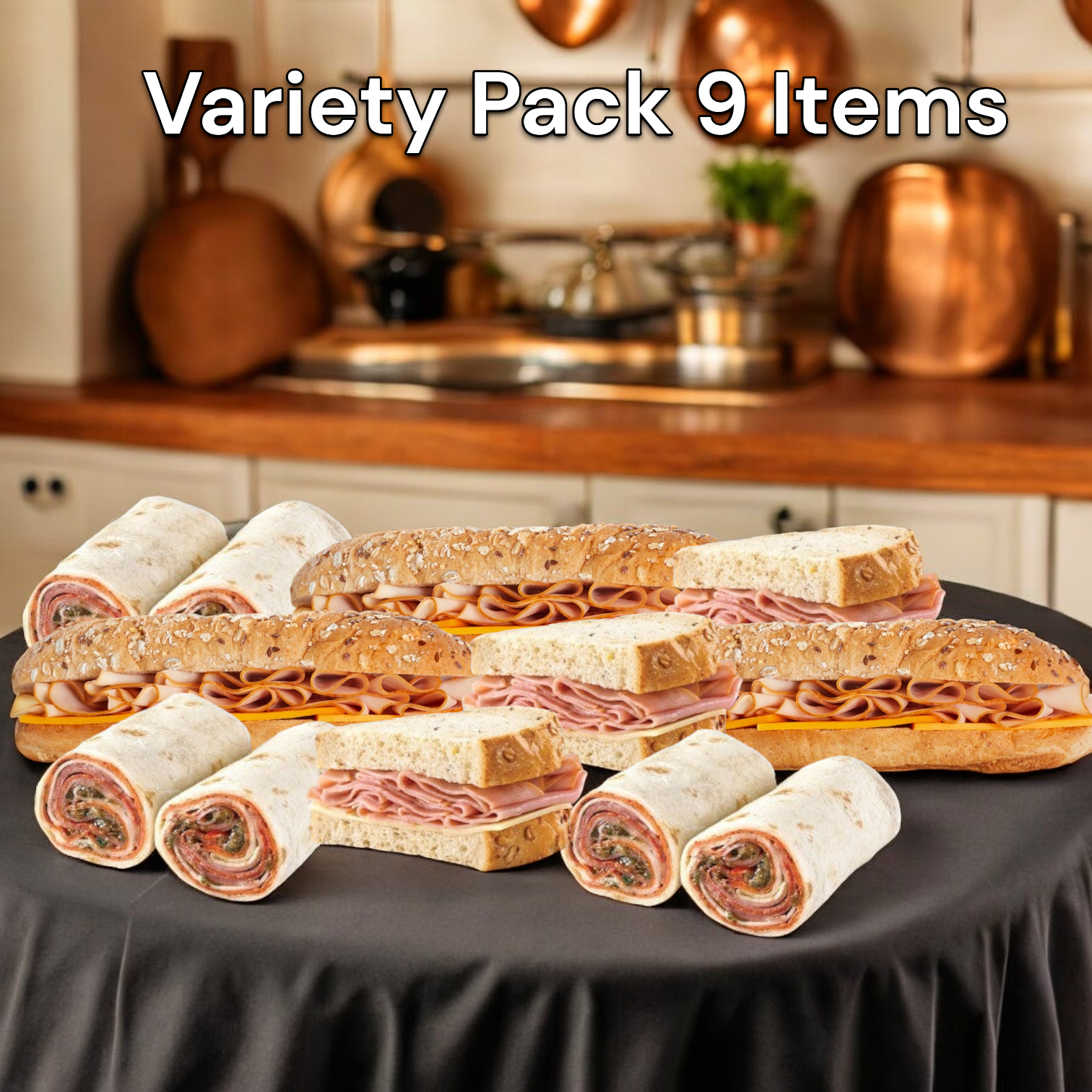 The Easy Lunches Variety Sandwich Pack 9 Items! showcases an assortment of handcrafted sandwiches, including 3 Smoked Turkey & Cheddar Sub Sandwiches, 3 Ham & Swiss on Rustic Oat Topped Wheat Bread, and 3 Italian Style Wraps, all beautifully arranged on a black tablecloth against a charming kitchen backdrop.