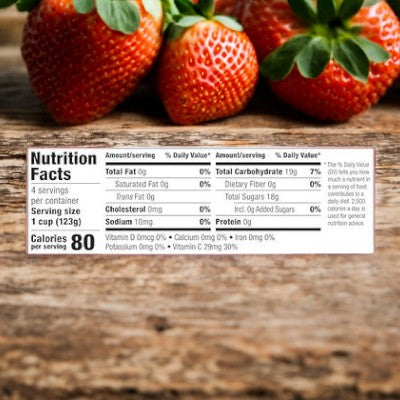 A Dole Wiggles Strawberry Fruit Juice Gel pack with a nutrition facts label is displayed in front of some strawberries, detailing the serving size (1 cup), calories (80 per serving), and amounts of fats, sodium, carbohydrates, fiber, sugars, protein, and Vitamin C.