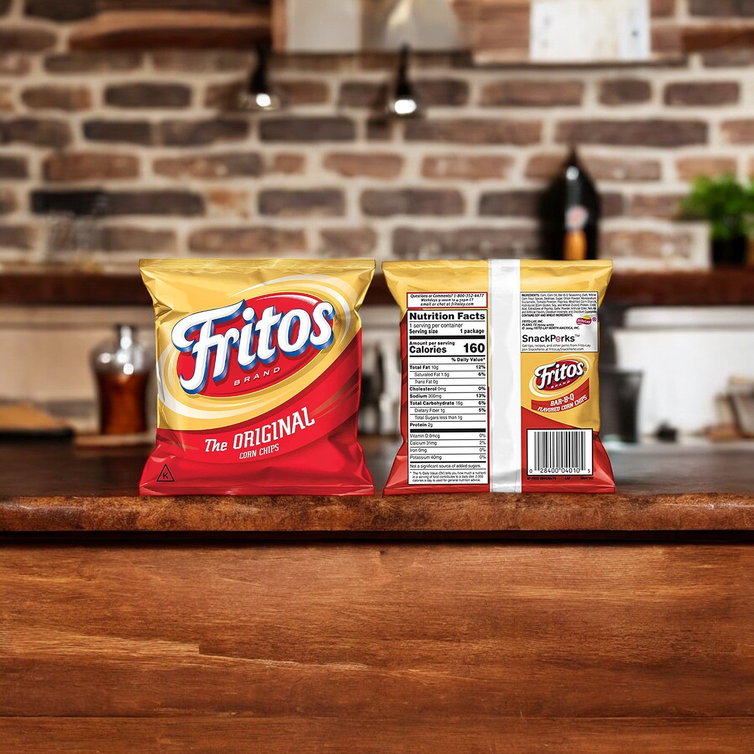 A single bag of Frito Lay's Fritos Original Corn Chips, 1 oz, is displayed on a wooden kitchen countertop; the front highlights the iconic branding, while the back reveals the nutrition facts. Perfect for on-the-go snacking, these chips bring out that classic flavor everyone loves.