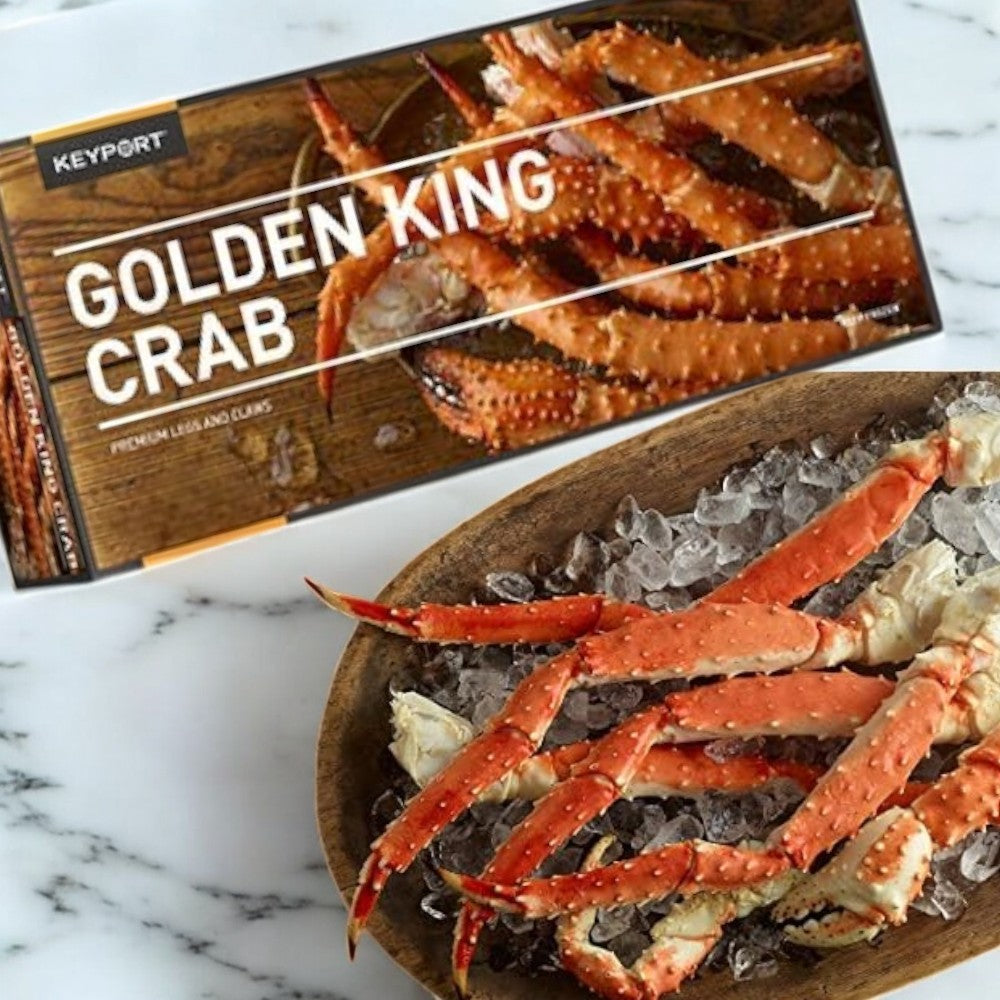 A Keyport Golden Alaskan King Crabs box sits beside a wooden bowl filled with ice and crab legs on a marble surface, highlighting premium quality seafood from sustainable sources. Brand: Keyport, Pack Size: 1 Pound.