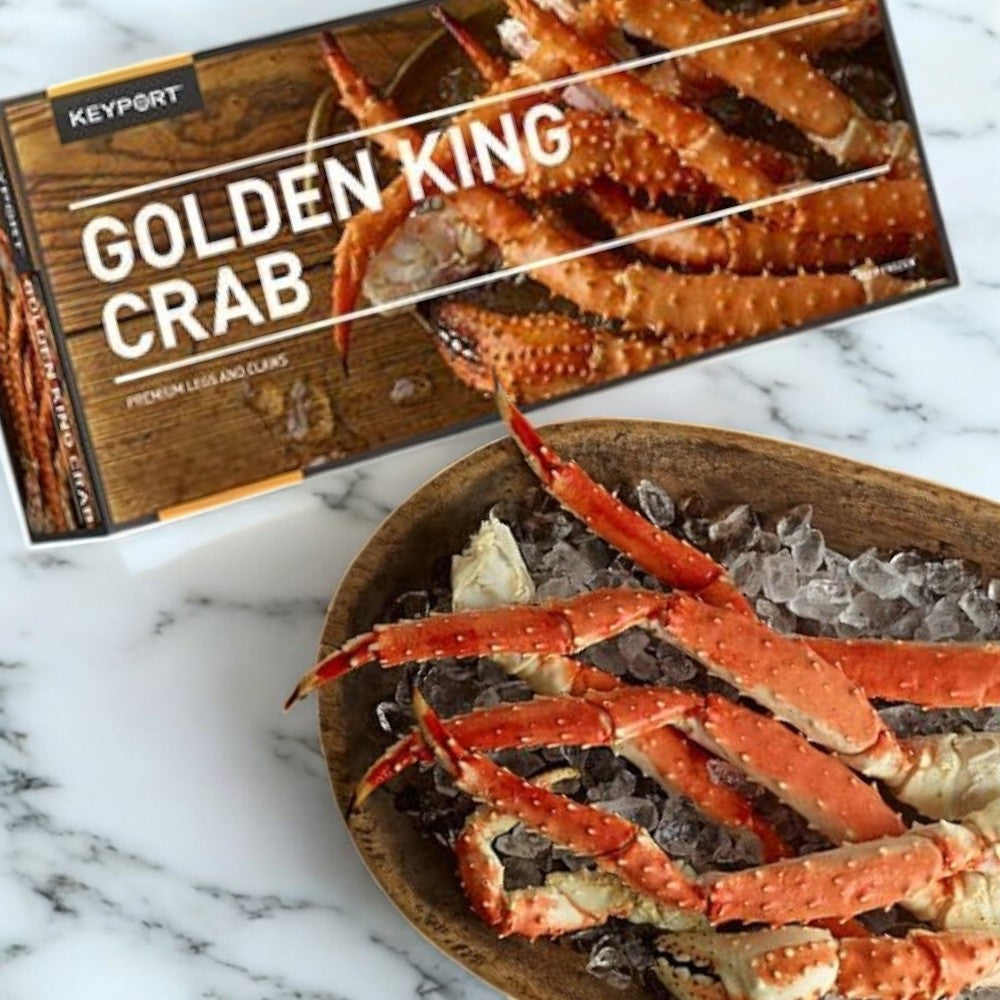 A 3-pound package and plate of Keyport's premium Golden Alaskan King Crab legs on a marble surface, highlighting sustainable sourcing.