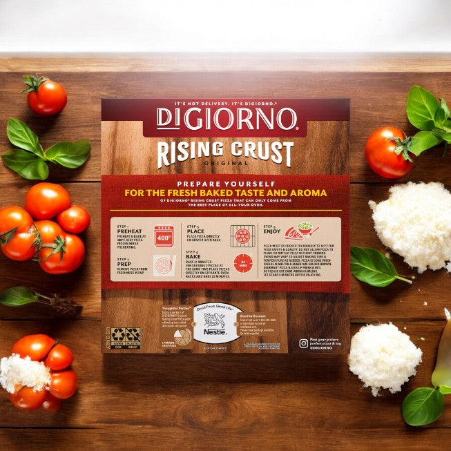 A box of DiGiorno Original Rising Crust Pepperoni Pizza rests on a wooden surface, encircled by fresh tomatoes, basil leaves, and grated cheese. The packaging highlights the use of quality ingredients and displays cooking instructions alongside promotional text celebrating their signature rising crust. The box contains three frozen pizzas from DiGiorno’s renowned brand.