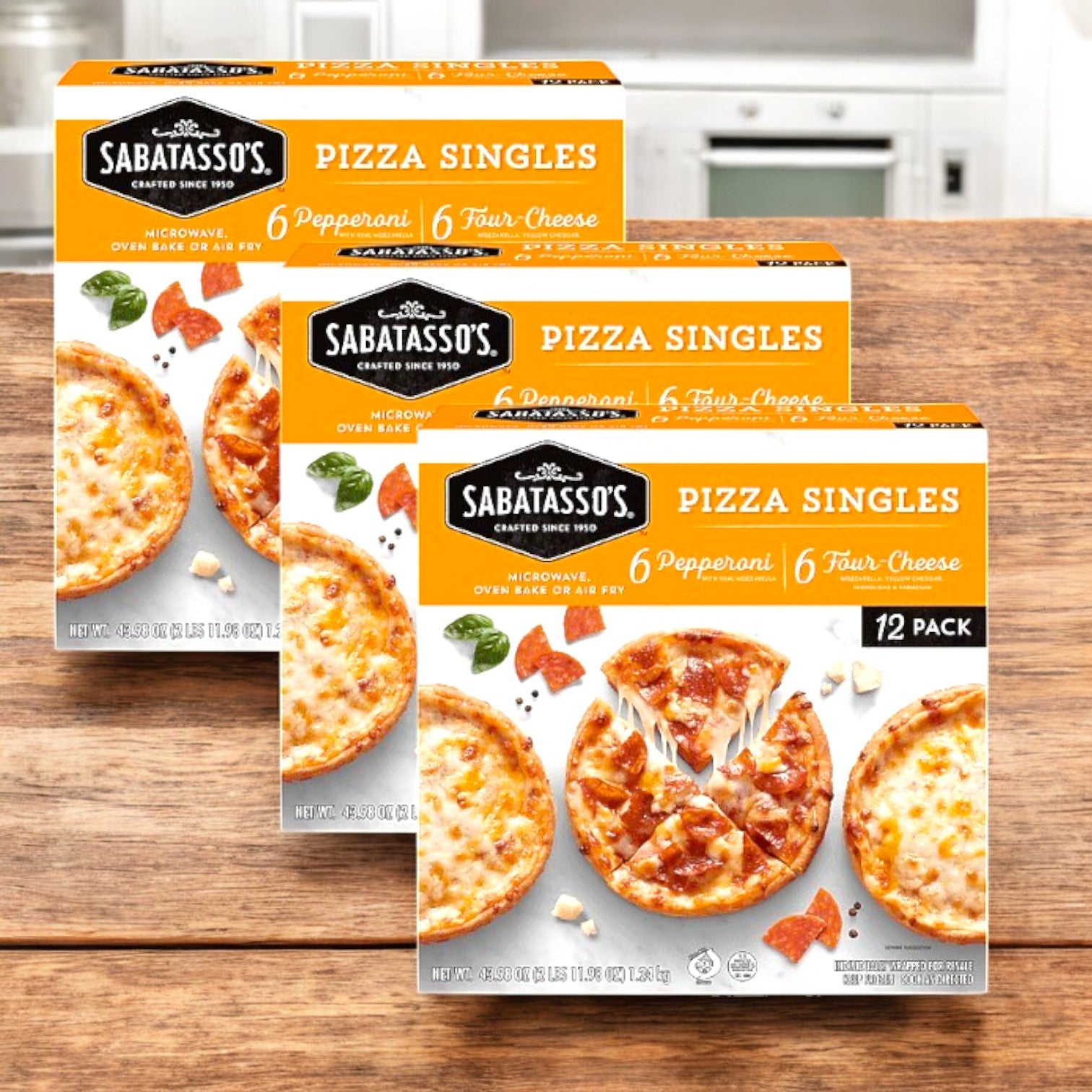 Boxes of Sabatasso's Pizza, Singles, Pepperoni/Four-Cheese (43.98 oz., 3 packs), elegantly arranged on a wooden surface in a cozy kitchen setting. These single-serve pizzas perfectly combine convenience and flavor for any pizza lover.