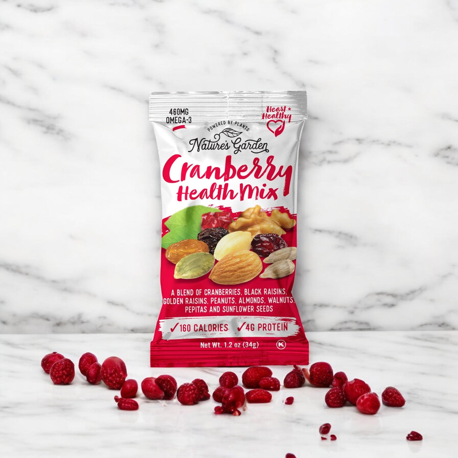 A packet of Nature's Garden Cranberry Health Trail Mix-1.2 oz- 1 Count rests on a marble surface, surrounded by scattered organic cranberries. The deluxe trail mix from Nature Garden includes a blend of cranberries, raisins, nuts, and seeds.