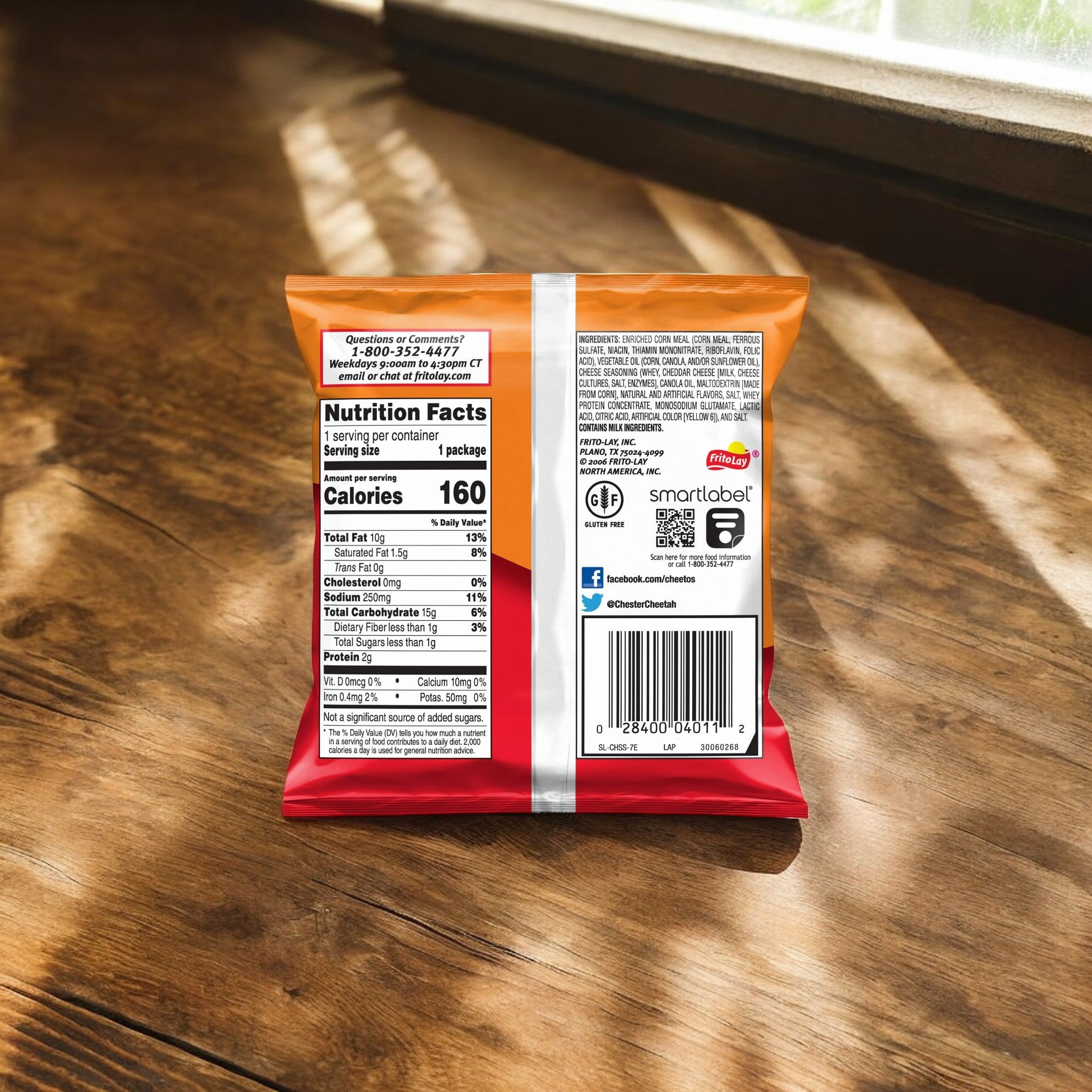 A 1 oz bag of Cheetos Cheese Chips from PepsiCo rests on a wooden table, displaying the back with nutrition facts, ingredients list, and a barcode. Sunlight streams through a nearby window, highlighting this crunchy snack made with real cheese and gluten-free ingredients.