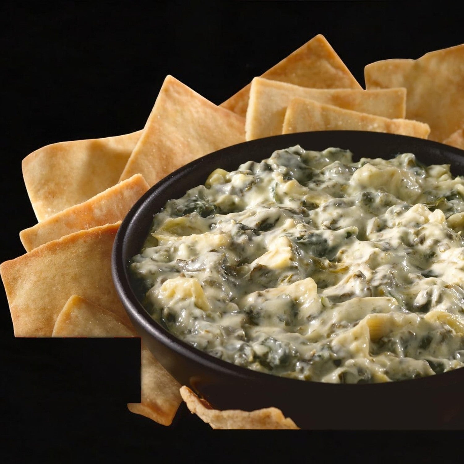 The TGIF Fridays Spinach & Artichoke Cheese Dip Frozen Snack, served with crispy tortilla chips, provides an indulgent and convenient experience.