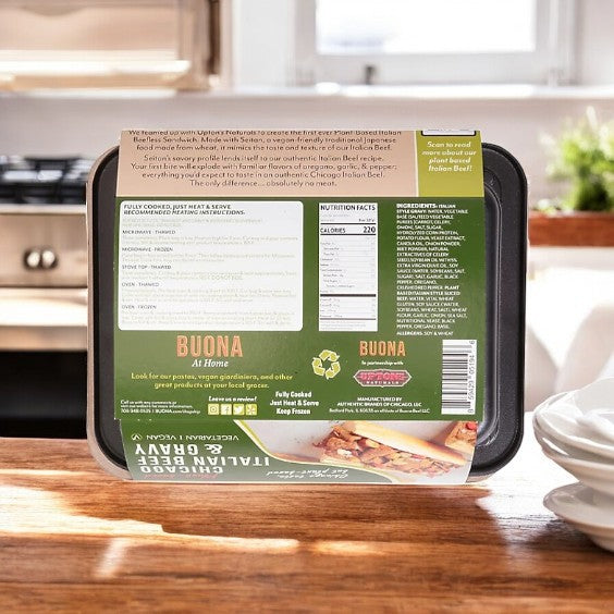 A Buona Plant-based Chicago Italian Beef & Gravy package (3 count) rests on the kitchen countertop, its nutritional details in view. Plates are stacked nearby, awaiting a plant-powered take on the meatless Chicago classic.