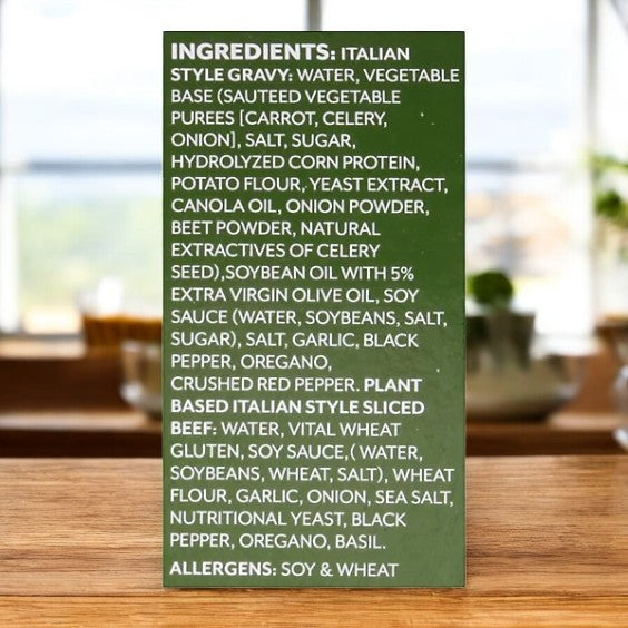 Buona Plant-based Chicago Italian Beef & Gravy label shows ingredients and soy/wheat allergens on a blurred kitchen background.