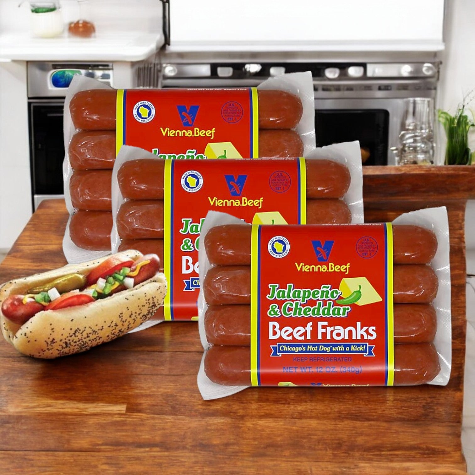 Three packs of Vienna Beef Jalapeno & Cheddar Beef Franks-3 Count by Vienna Beef rest invitingly on the counter. In front, a hot dog bursts with spicy jalapeños and gooey cheese, highlighting these premium franks in all their tasty glory.