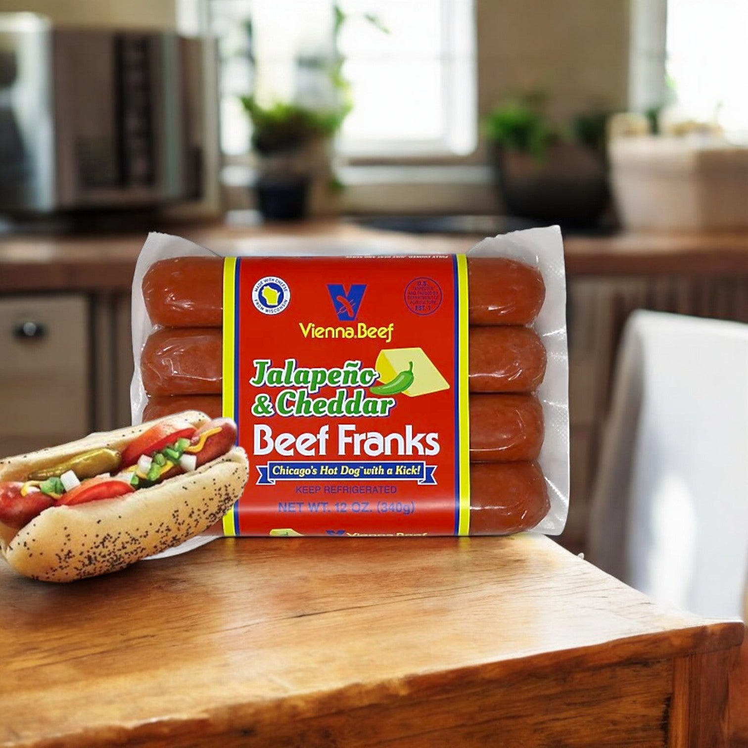 A package of Vienna Beef Jalapeno & Cheddar Beef Franks sits on the kitchen table, featuring a hot dog in a bun with the spicy zest of jalapeños and onions. These premium beef franks from Vienna Beef guarantee a flavorful bite every time.