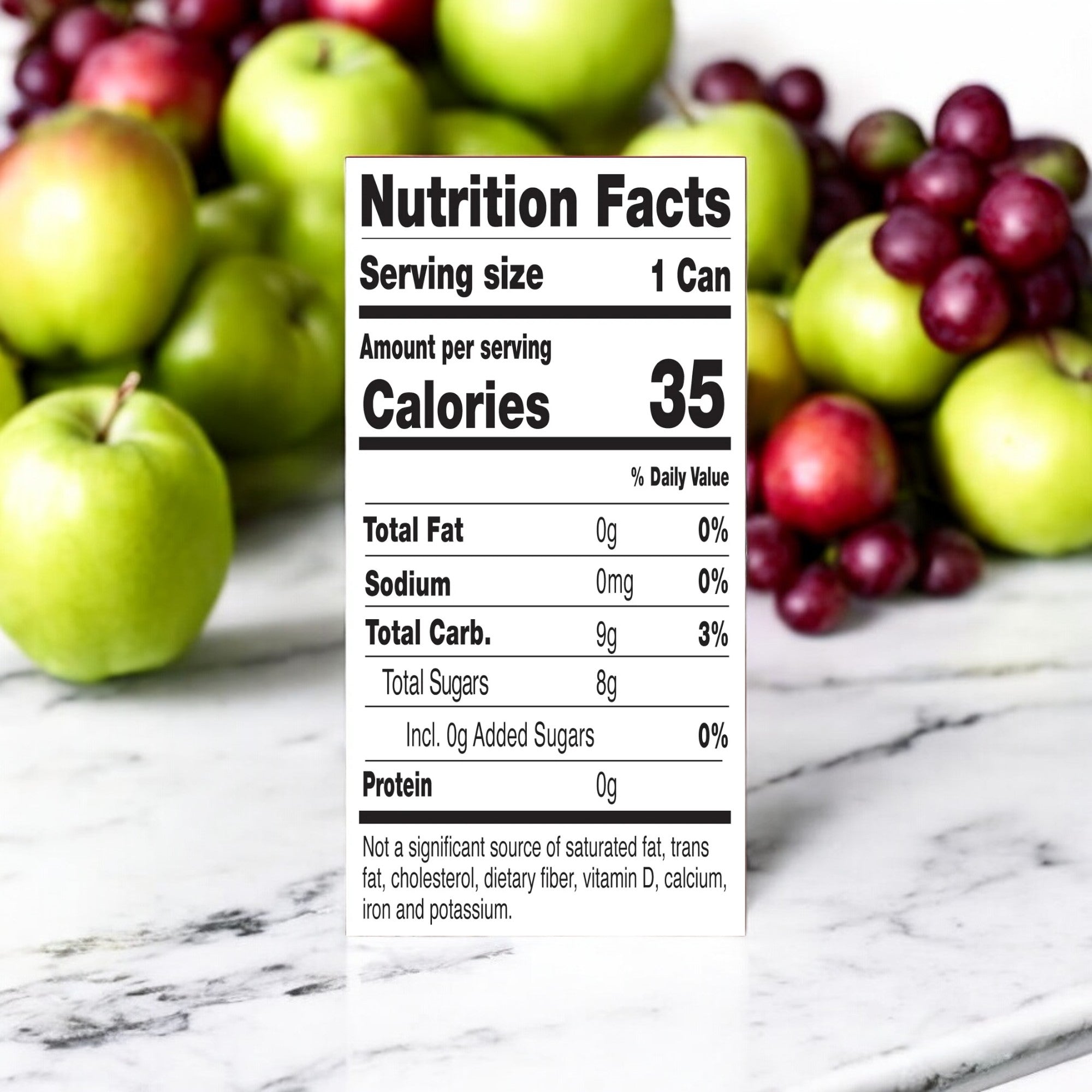 A nutrition facts label for GoodPop Just Juice + Bubbly Water Mini Cans Fruit Punch indicates 35 calories per 7.5 oz serving (1 can), with no fat, sodium, protein, or added sugar, and a total of 9g carbs. The background features green and red apples on a marble surface.
