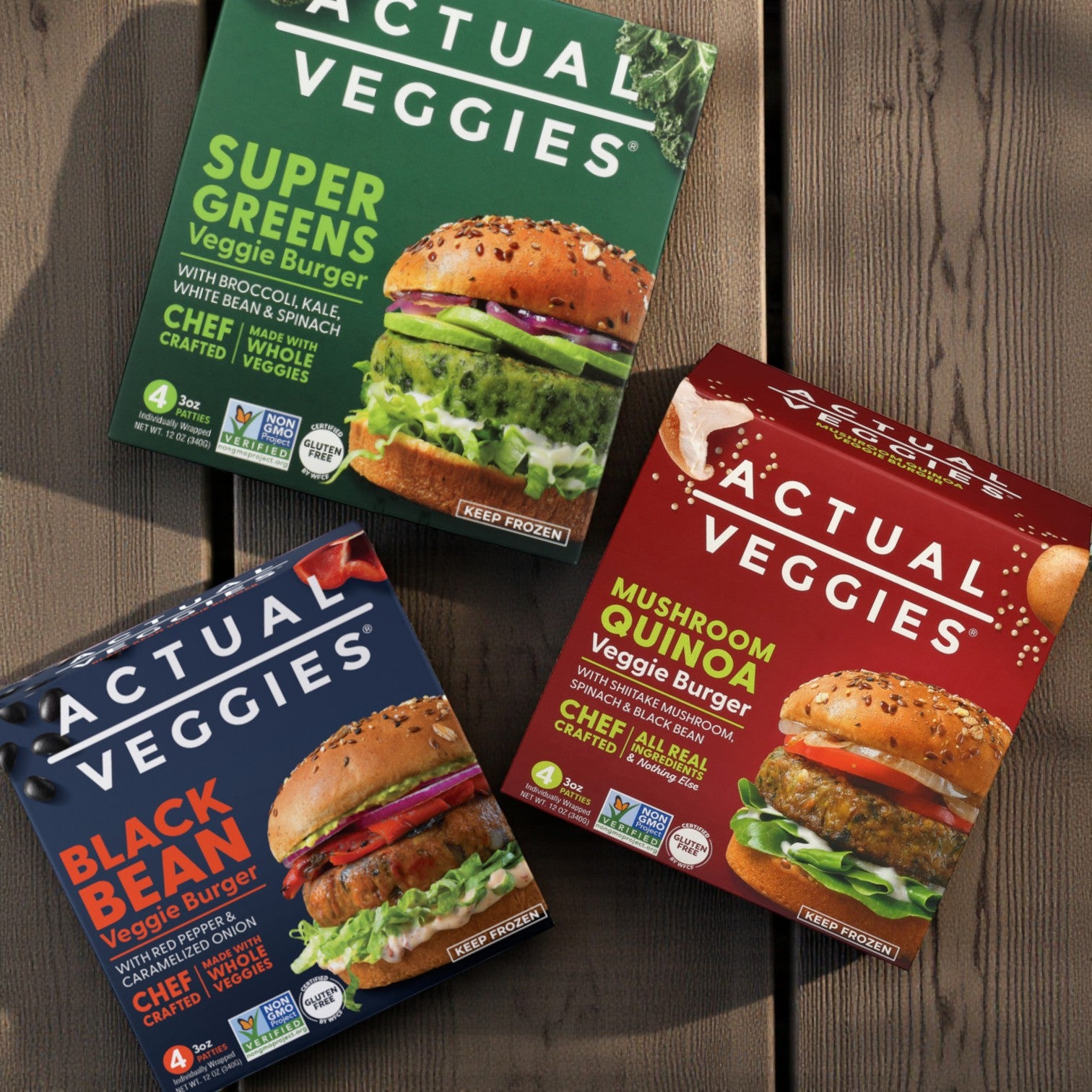Actual Veggies Combo 3-Pack—Super Greens, Mushroom Quinoa & Black Bean (4 x 3 oz each)—is displayed on a wooden surface, highlighting delicious plant-based burger options.