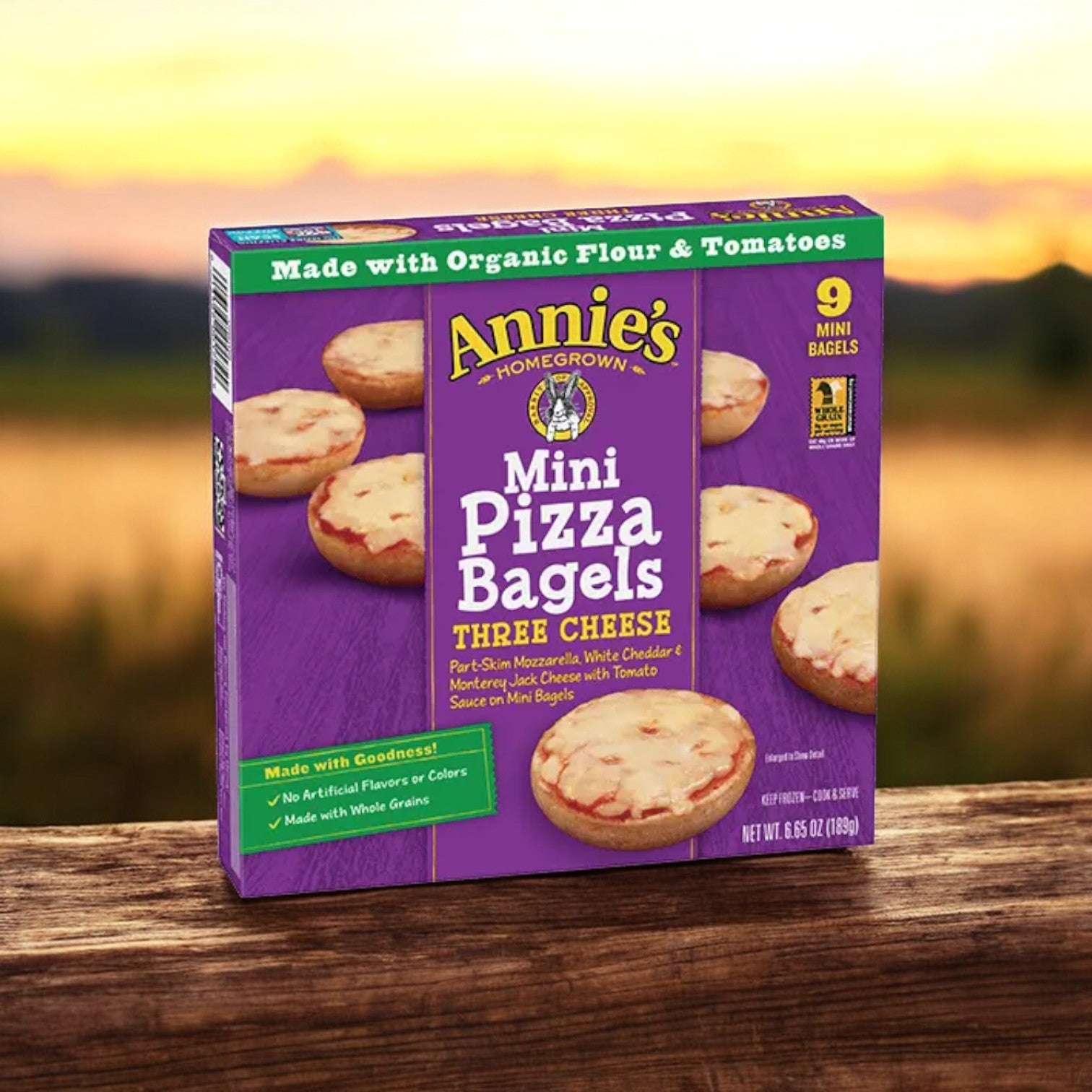 The Annie's Three Cheese Mini Pizza Bagels, 6.65 oz. - 1 Count, feature a delicious "Three Cheese" label and the delightful addition of Uncured Pepperoni. Made with organic flour, tomatoes, and whole grain bagels, this box contains nine bagels and ensures that no artificial flavors or colors are included.