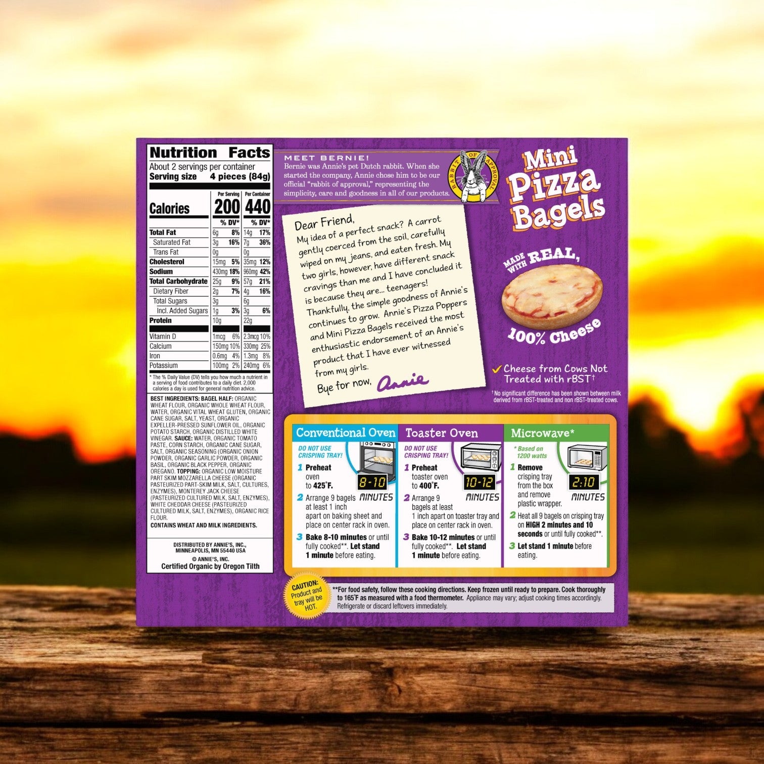 Back of an Annie's Three Cheese Mini Pizza Bagels box highlighting nutritional information, a cooking instructions chart, and a heartfelt letter from Annie's. Crafted with organic ingredients and whole grain bagels for a wholesome snack experience.