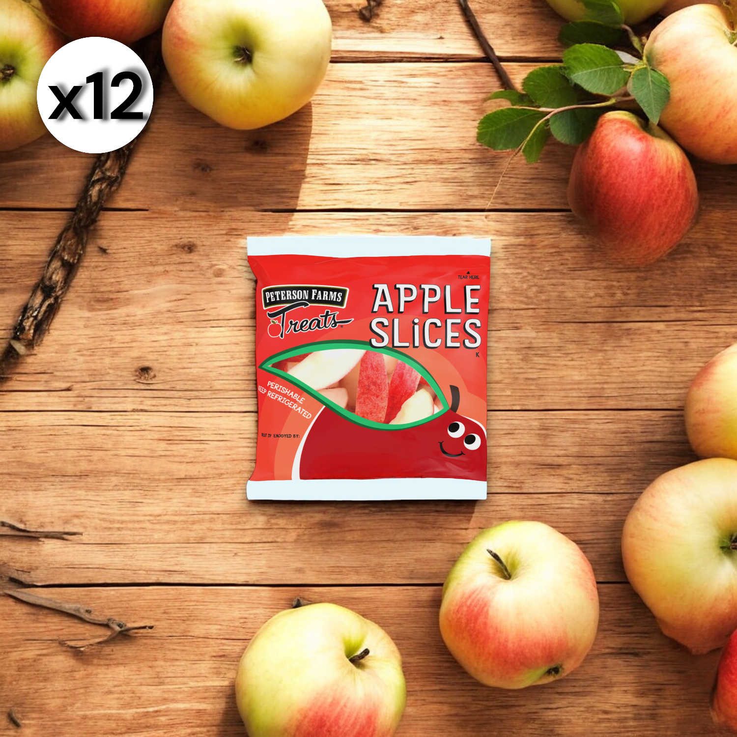 A package of "Peterson Farms Fresh Apple Slices," a 2 oz. product from Peterson Farms, is positioned amongst natural apples on a wooden surface, presenting a wholesome snack choice.