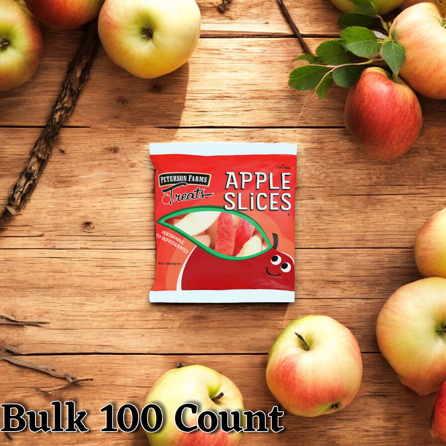 A package of Peterson Farms Fresh Apple Slices, 2 oz. - Bulk 100 Count, placed on a wooden surface surrounded by fresh apples and twigs. Text reads: "Bulk 100 Count." Perfect for convenient snacking, these apple slices from Peterson Farms are a healthy option sure to please everyone.