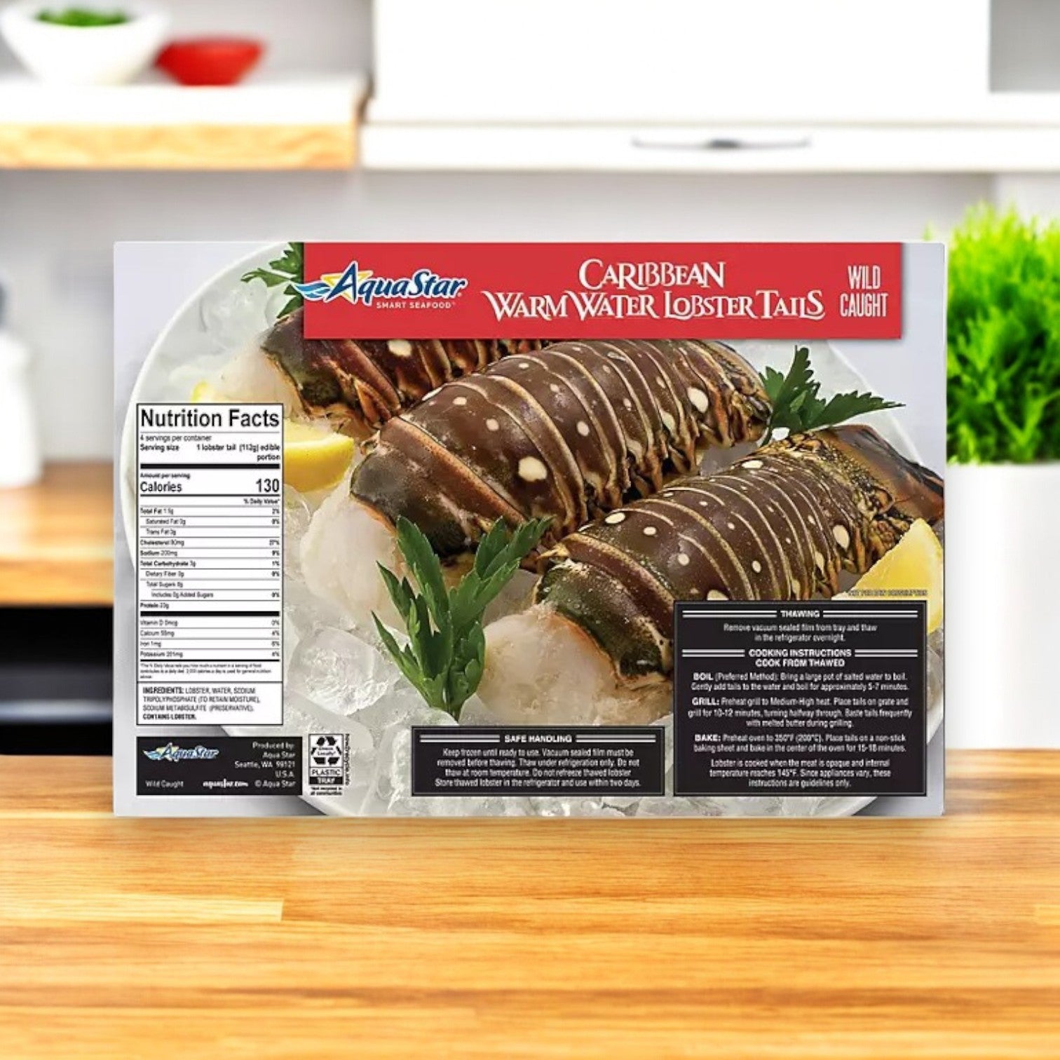 A package of Aqua Star Wild Caught Caribbean Warm Water Lobster Tails, Frozen, rests on a kitchen counter, featuring nutrition facts and preparation instructions while highlighting the brand’s dedication to sustainably harvested seafood.