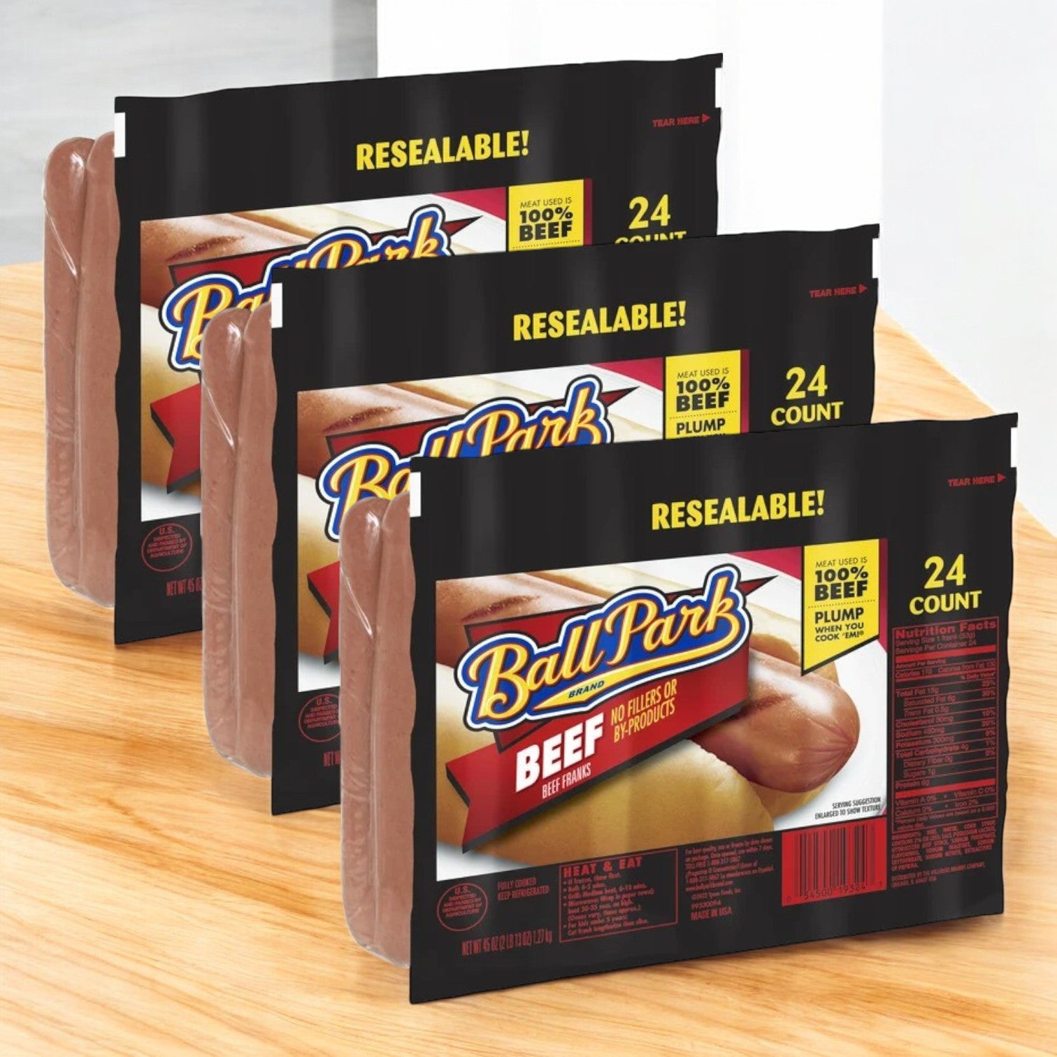 Three resealable packs of Easy Lunches Ball Park Beef Franks (72 total) are displayed on a wooden surface—ideal for your next BBQ or family cookout.