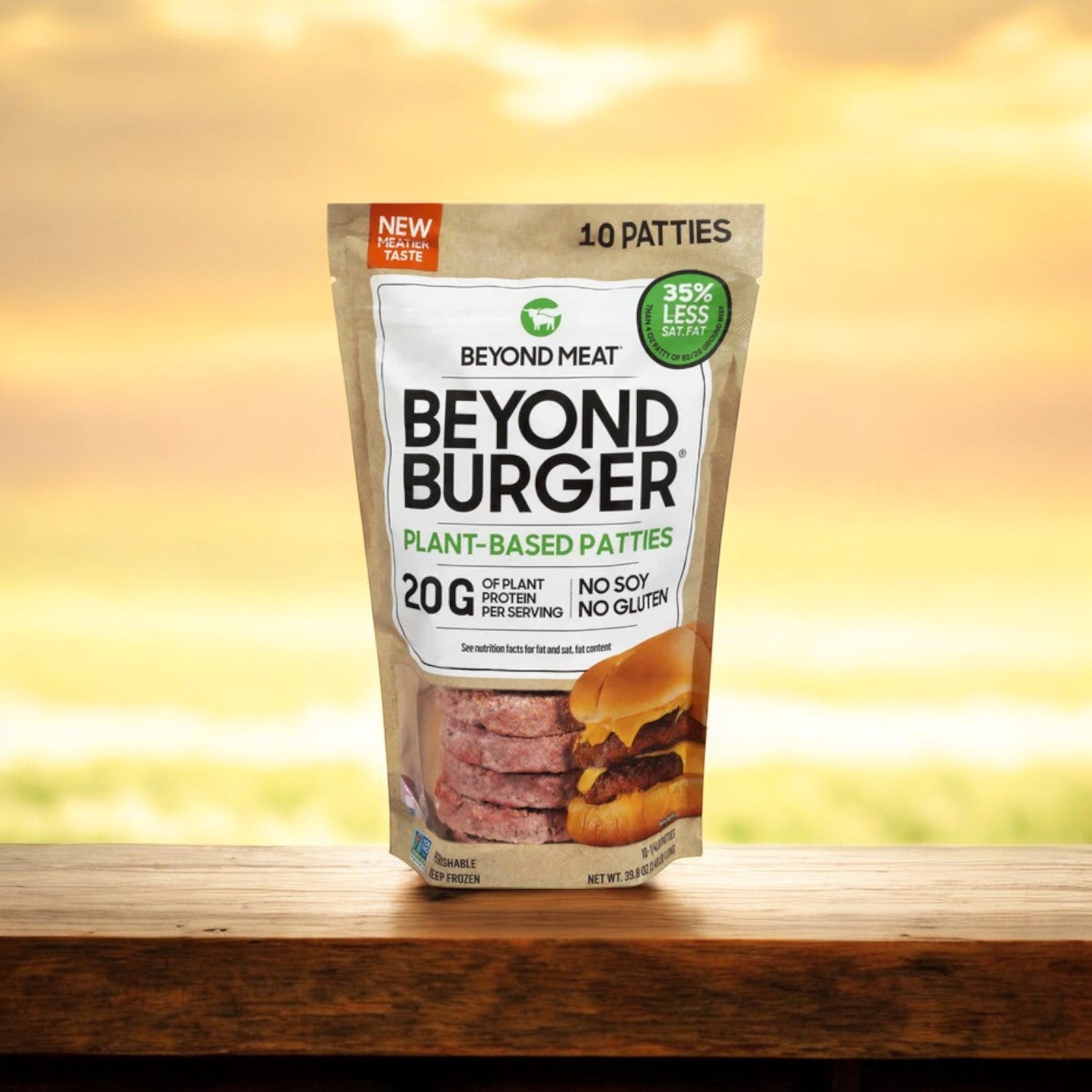 A 39.8 oz package of Beyond Meat's Beyond Burger, containing ten plant-based patties, is displayed on a wooden surface. Prominent labels indicate "20g plant protein" and "no soy, no gluten," emphasizing its eco-friendly benefits against an out-of-focus outdoor backdrop.