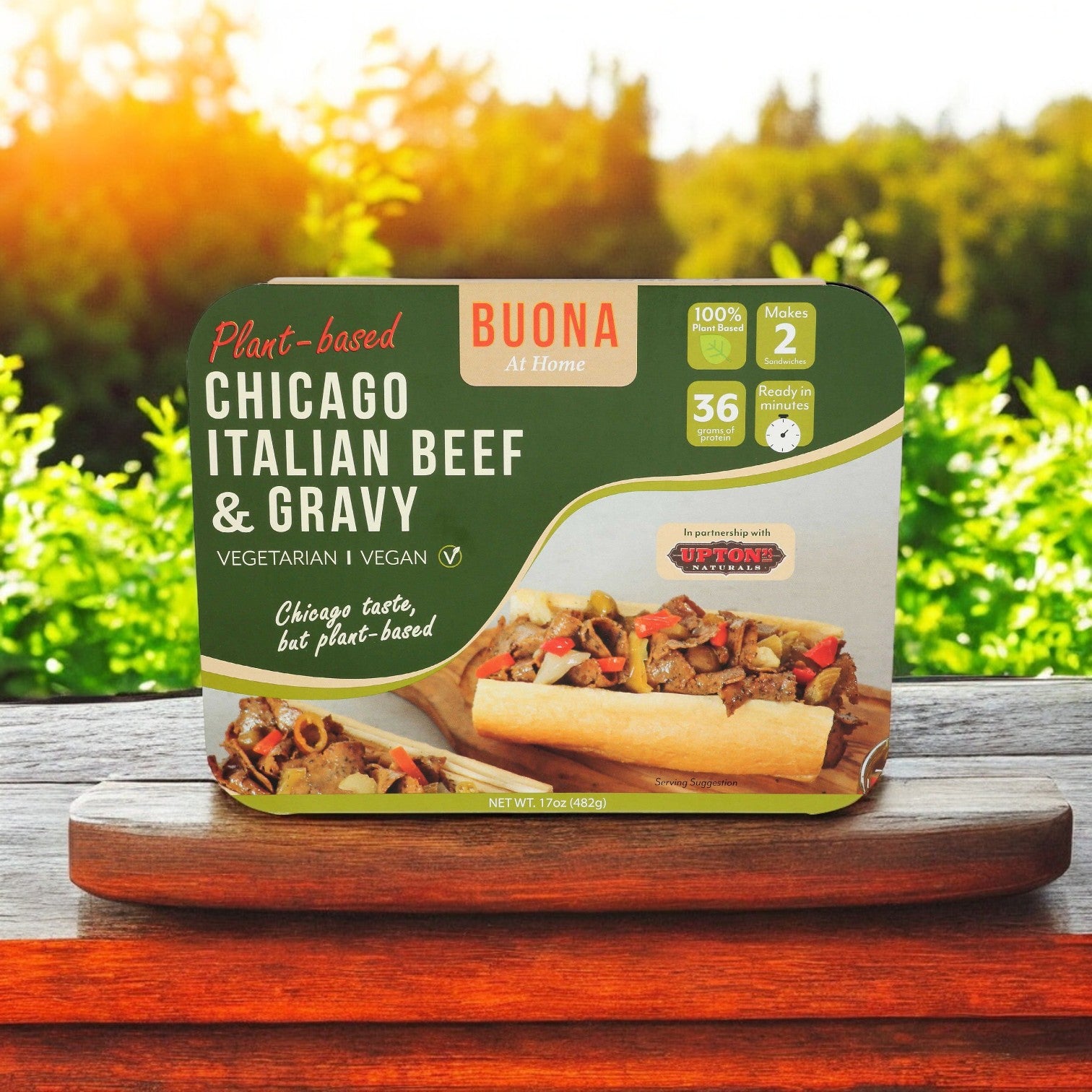 The Buona Kit Combo! by Easy Lunches is elegantly displayed on a wooden board, capturing the essence of Italian Beef Sandwich Entrées against a lush backdrop of green foliage.