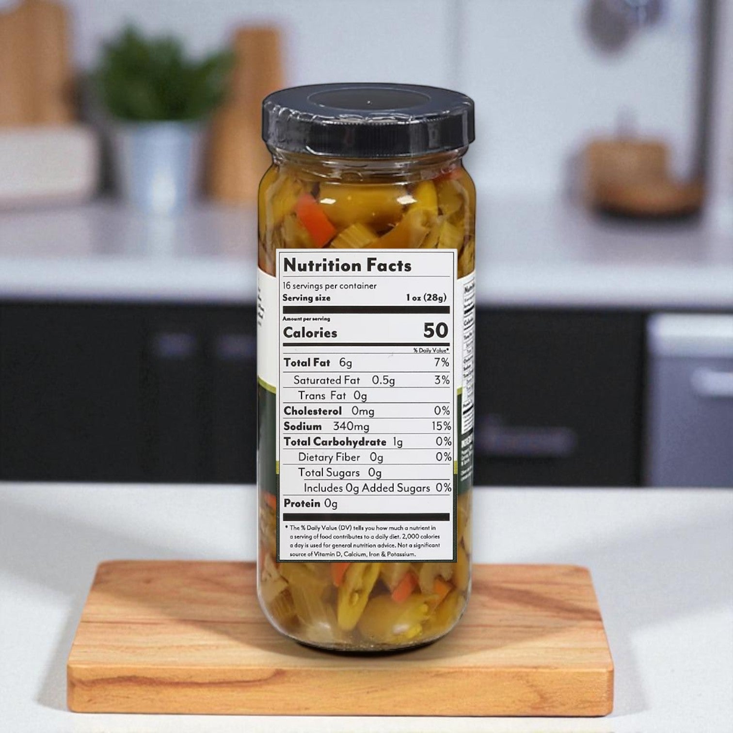 A 16 oz glass jar of Buona Giardiniera, Hot, Chicago Style by Buona with a visible nutrition label sits on a wooden board next to handcrafted sausage in a modern kitchen.