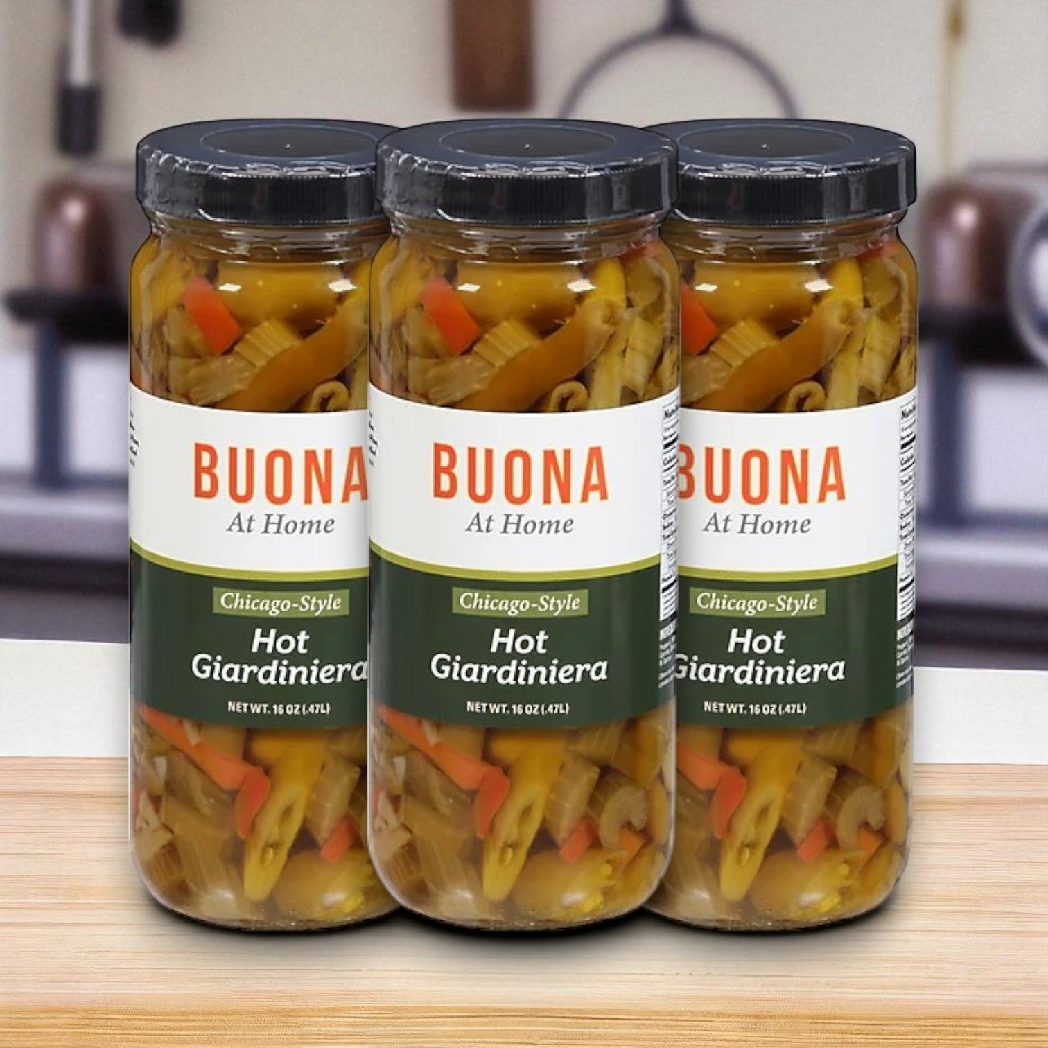 Three 16 oz jars of Buona Giardiniera, Hot, Chicago Style (3-Pack) by Buona are displayed on a wooden surface, ideal for adding spicy flavor to Italian beef sandwiches in your kitchen.