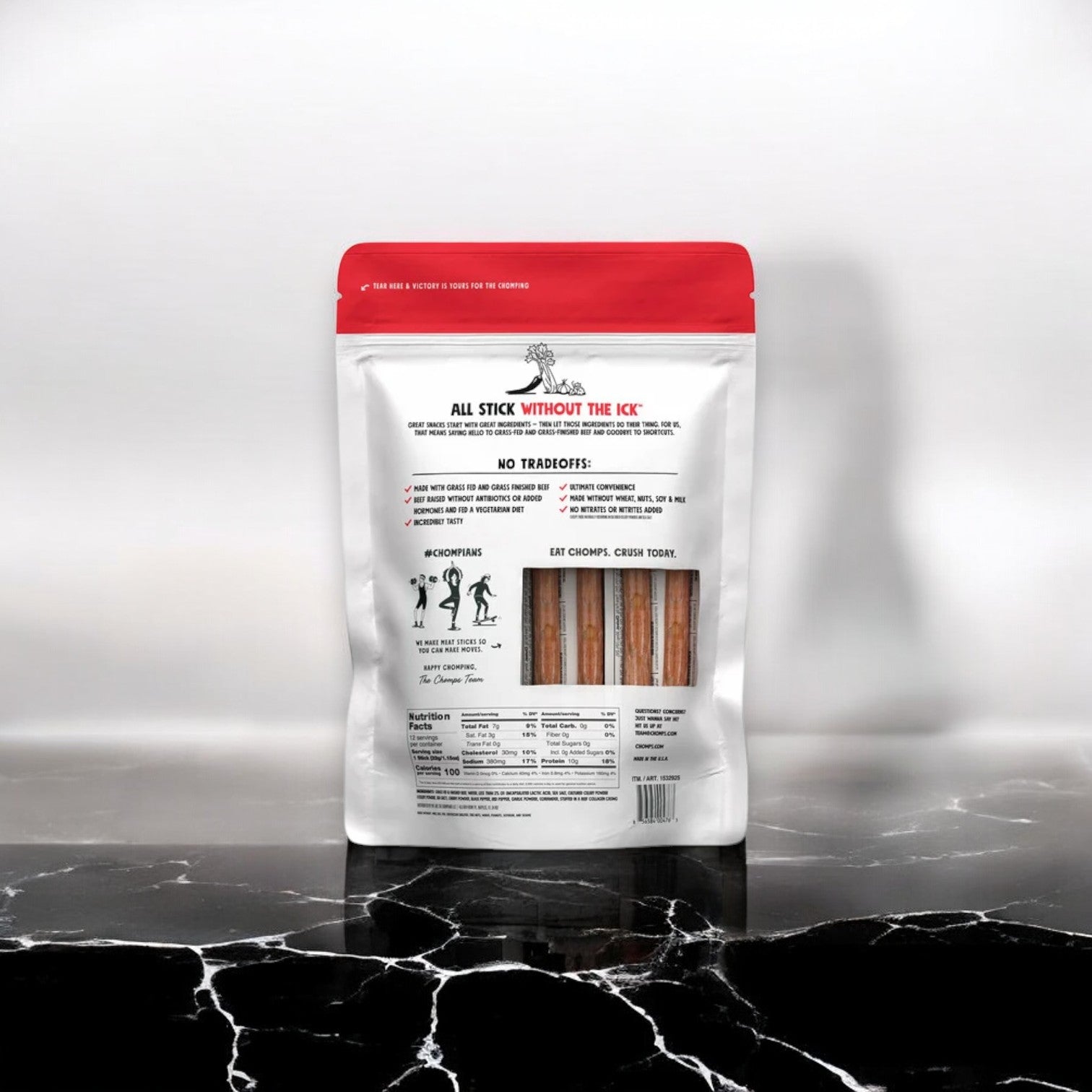 A package of Chomps Mild Original Beef Sticks, containing 12 individually wrapped sticks, rests on a black marble surface. The white packaging with a red top highlights the benefits and ingredients of this protein-packed snack made from grass-fed beef.