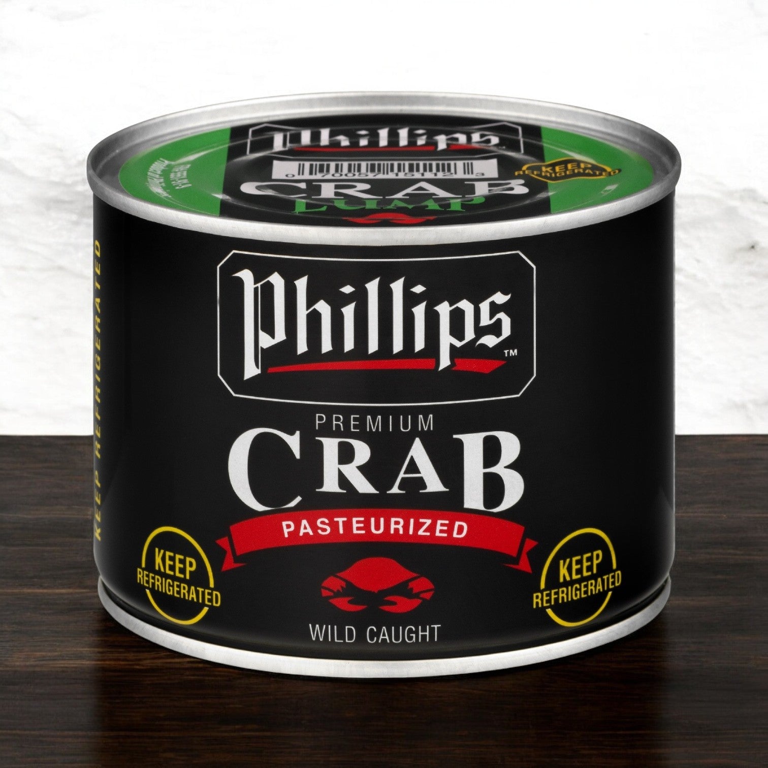 Can of Phillips Foods Crab Meat Lump, featuring a black label with red accents and information stating it's pasteurized and wild-caught. Sustainably sourced from Southeast Asia, be sure to keep it refrigerated.