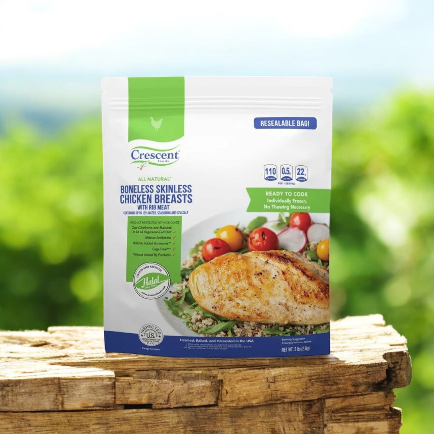 A resealable bag of Crescent Foods Halal Chicken Breast, 5 lbs, labeled as all-natural with high-quality protein, rests on a wooden surface. The packaging displays nutritional data and an appetizing cooked chicken image, offering a delicious and mindful meal choice.