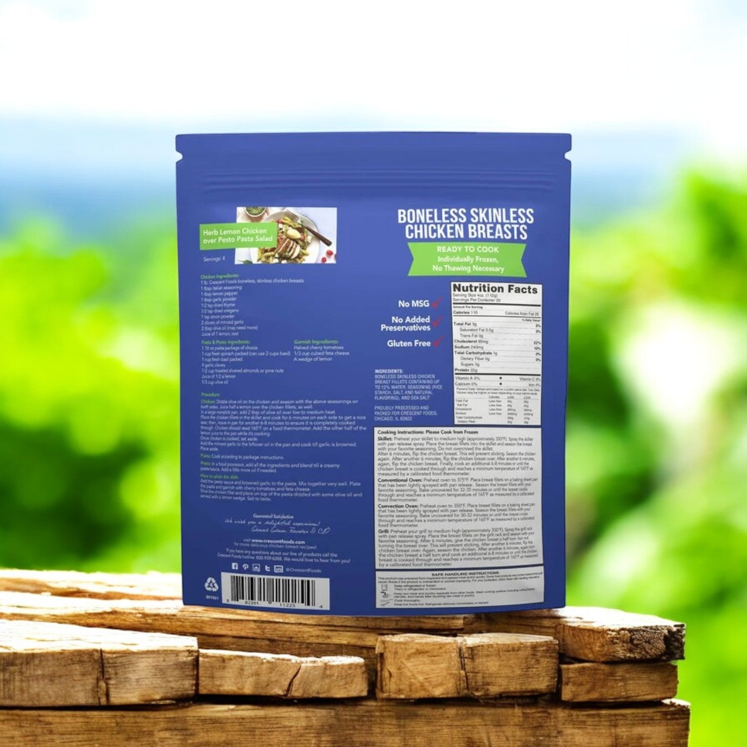 A blue-packaged 5 lbs "Crescent Foods Halal Chicken Breast" sits outdoors on wood with blurred greenery behind, featuring nutritional info. Enjoy all-natural, halal chicken breast from Crescent Foods, offering high-quality protein for your meals.