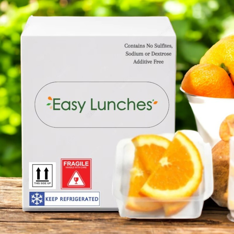 The Easy Lunches white package features sliced oranges, rich in vitamin C, in a clear container with cautionary labels for handling and refrigeration. The 2.5 oz., made-to-order oranges have a 7-day shelf life upon receipt.