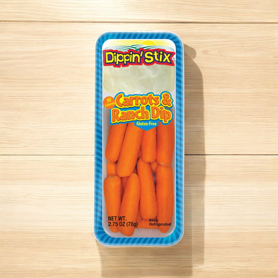 A pack of Dippin' Stix Baby Carrots & Ranch Dip Snack Pack, 2.75 oz (78g), with a gluten-free label, placed on a wooden surface.