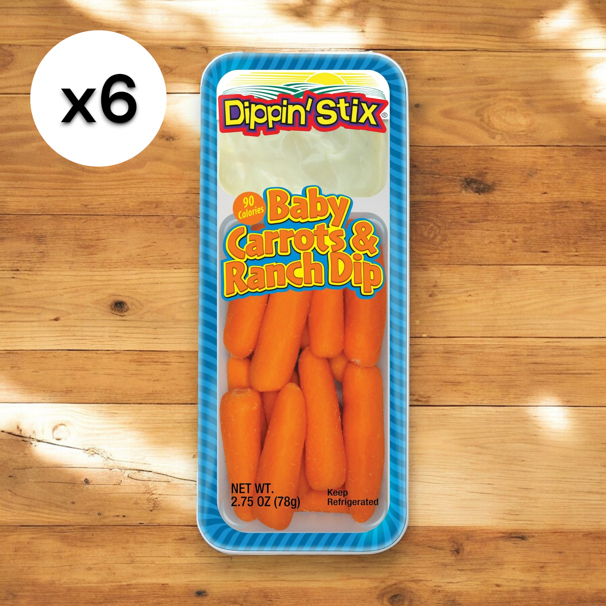 A pack from the Dippin' Stix Pack Baby Carrots & Ranch Dip 6-pack by Easy Lunches, weighing 2.75 oz, sits on a wooden surface. This healthy snack includes baby carrots and a container of ranch dip with a label indicating 90 calories. A "x6" symbol is displayed on the side.