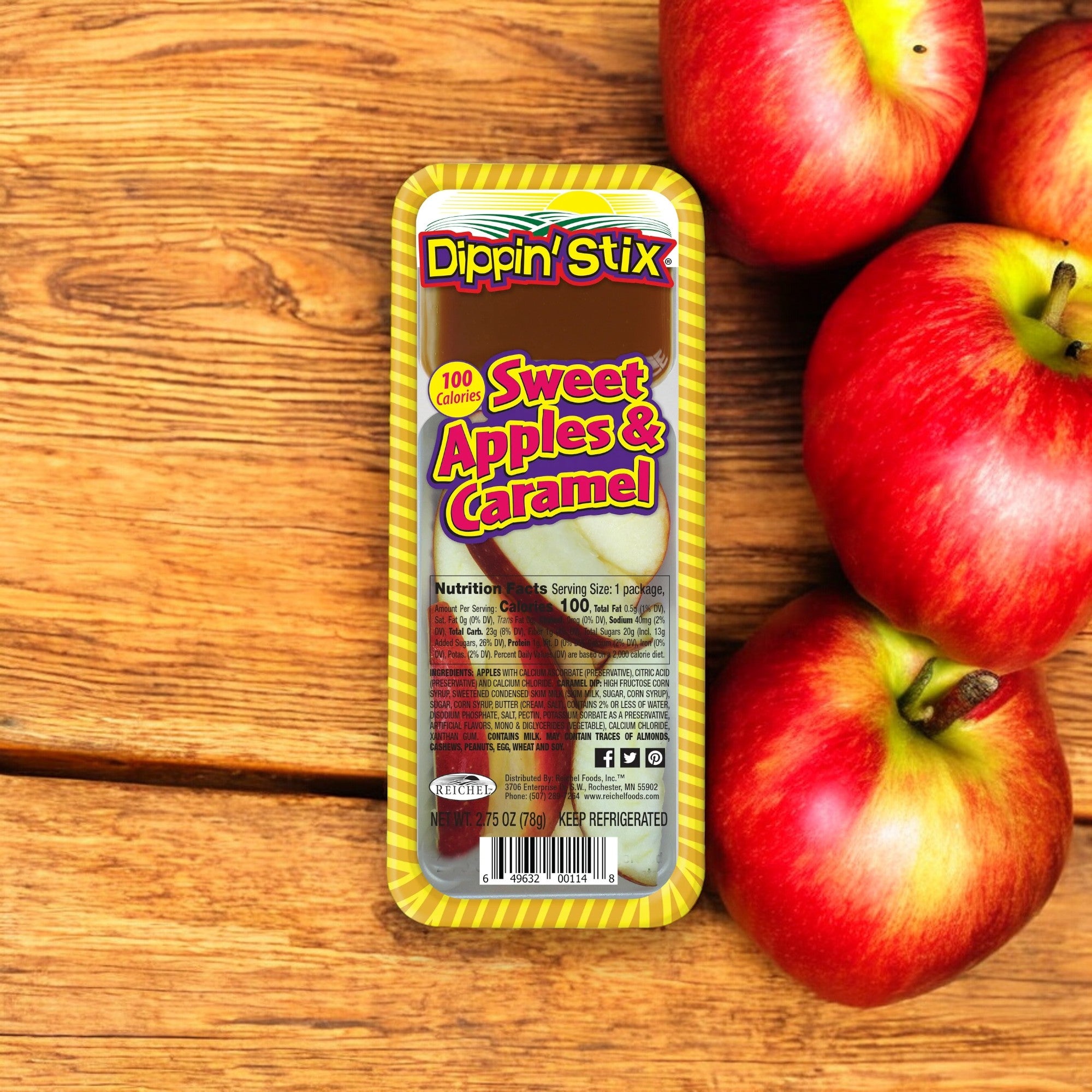 A package of Dippin' Stix Fresh Gala Sliced Apples and Caramel - 2.75 oz - 1 Count is displayed on a wooden surface next to a cluster of red apples.