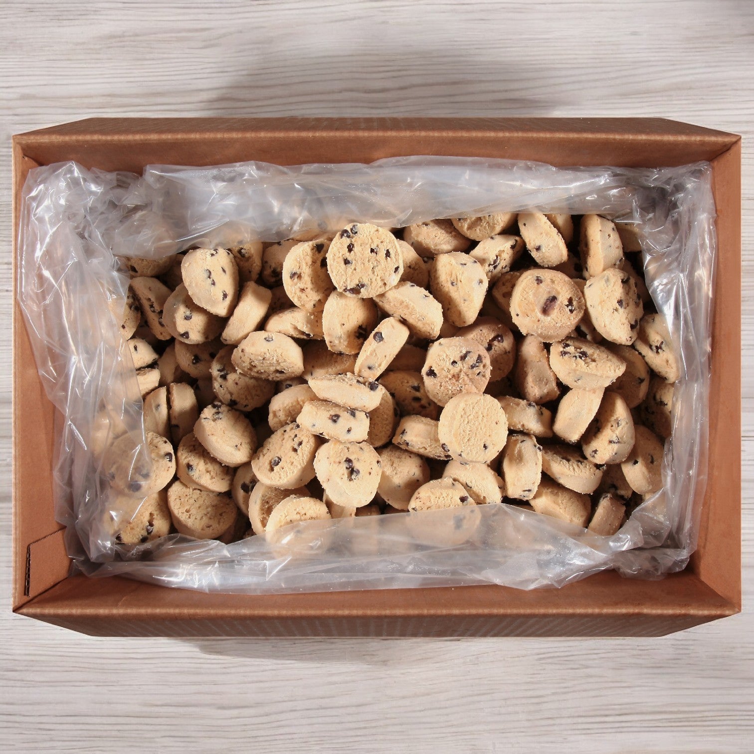 A clear plastic bag containing pre-portioned Otis Spunkmeyer Dough Cookie Chocolate Chip, with a total count of 320 in one case.